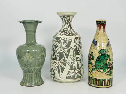 A Group of Three Asian Ceramic Vases: Comprising a Korean slip-decorated stoneware vase, with a maker's mark to the bottom, 11.1/4 in. high, 5.1/4 in. wide; a Korean celadon-glazed vase, 9.3/4 in. high, 4.1/2 in. wide; and a Japanese sake