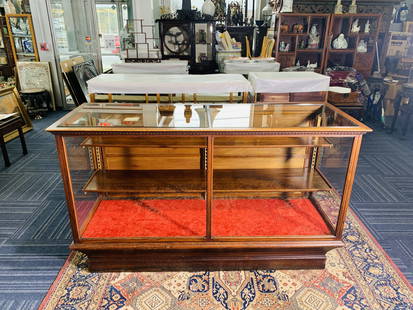 An Antique Large Oak Floor Showcase: It features an all-oak frame that sits atop a slightly tapered matching base. The case features a set of corner posts designed to accommodate adjustable-height shelves. Two shelves are included. 42 in