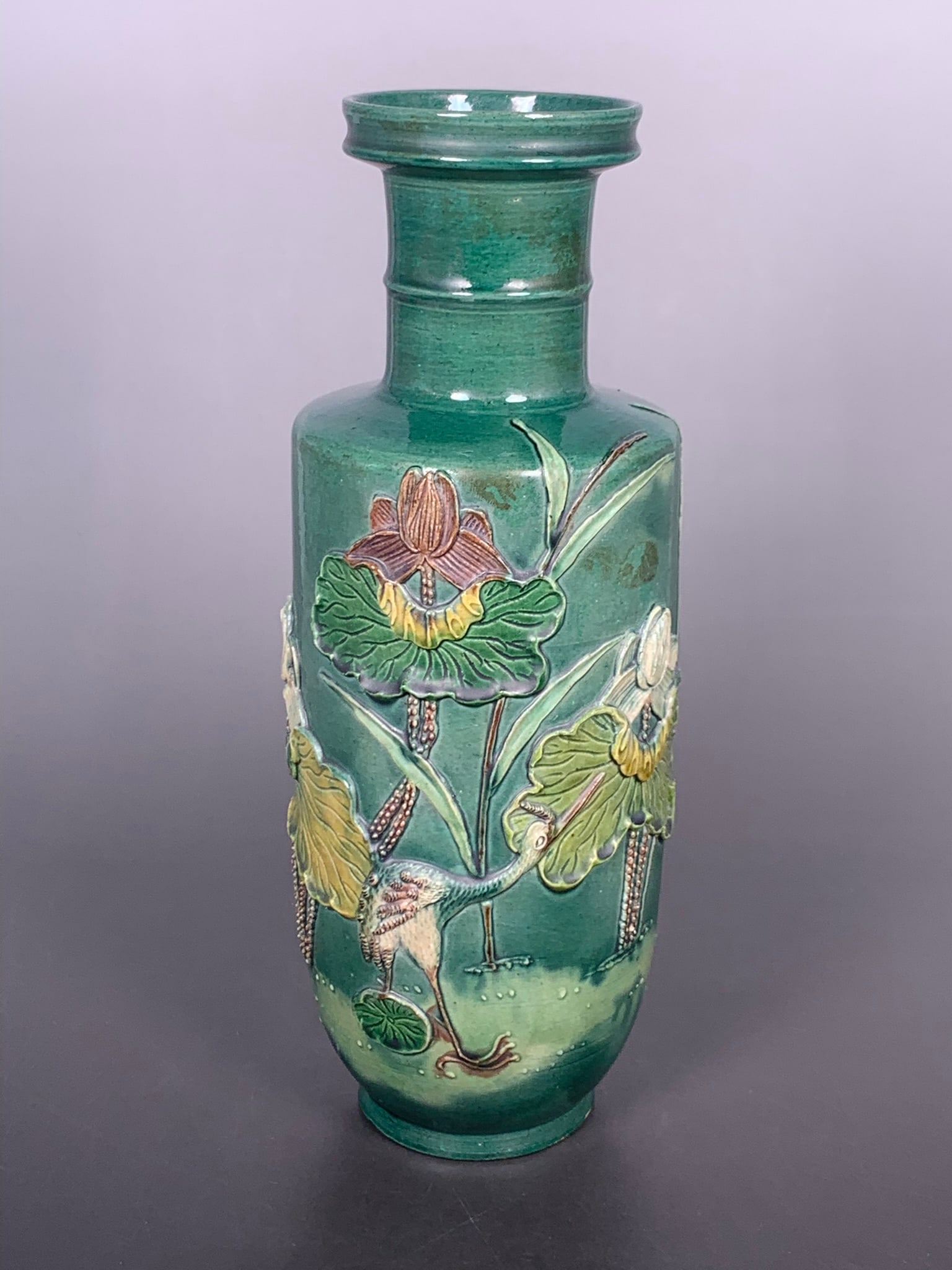 A Chinese Polychrome Molded Porcelain: With relief crane and lotus design. 11 in. high, 3.3/4 in. wide.