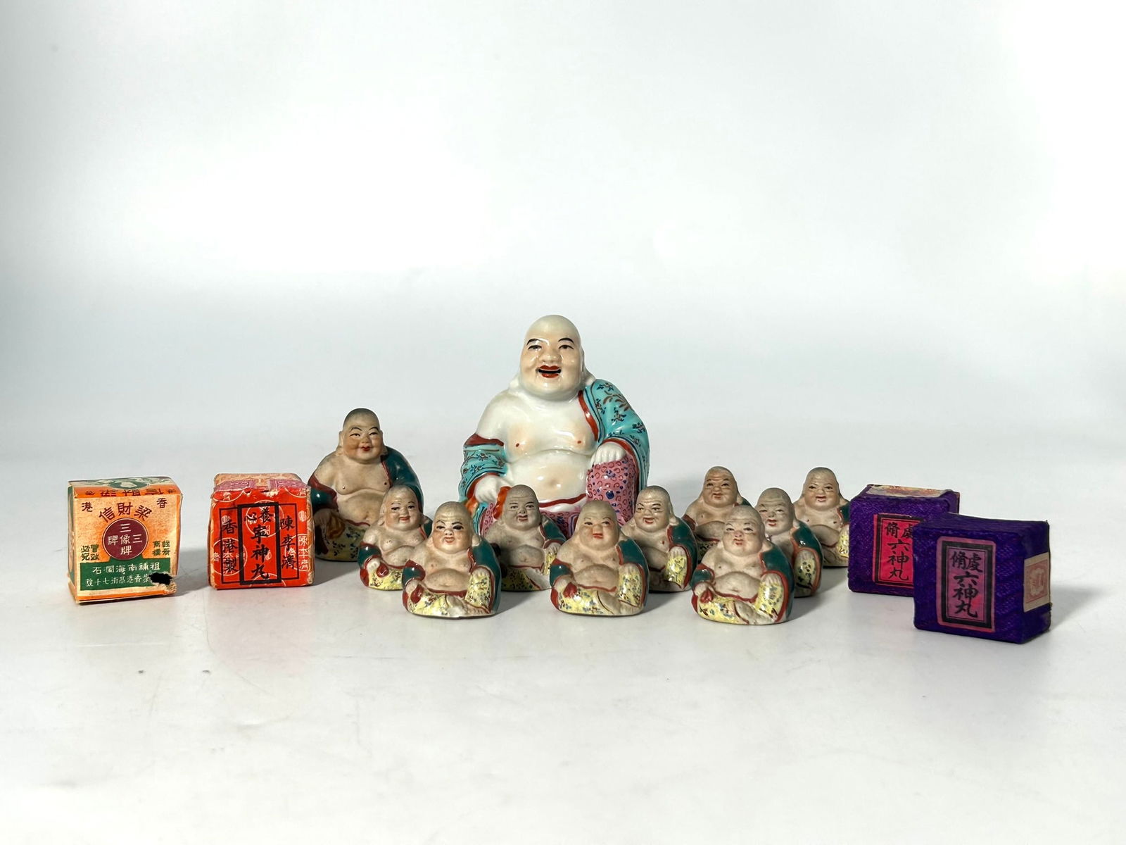 A Group of Eleven Miniature Famille Rose/Painted Pottery Figures of Budai (1 of 16)