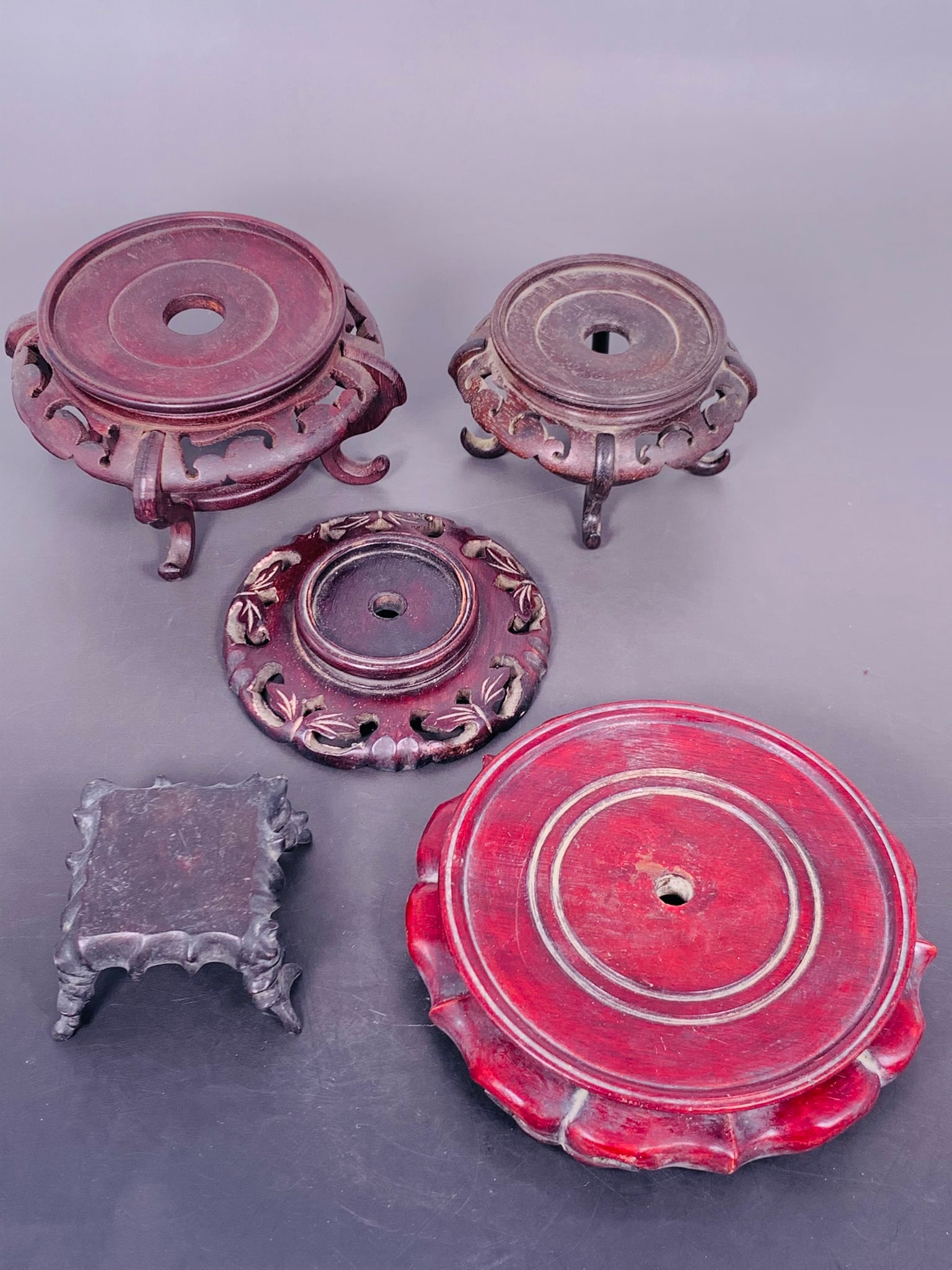 A Group of Five Chinese Wood Stands: The largest measures 1.3/4 in. high, 7.3/8 in. wide.