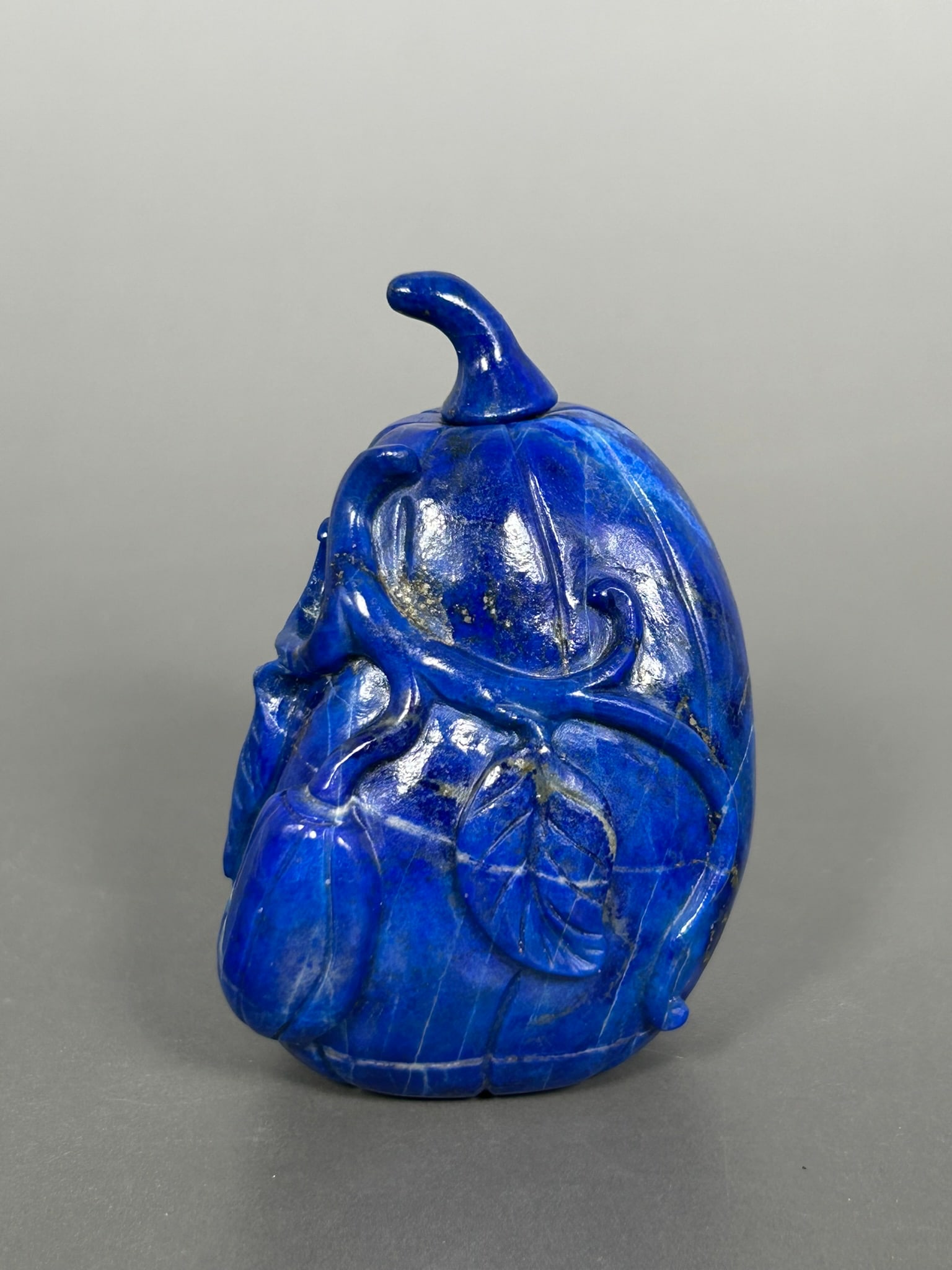 A Chinese Carved Lapis Lazuli Melon-Form Snuff Bottle: 3 in. high, 2.1/8 in. wide.