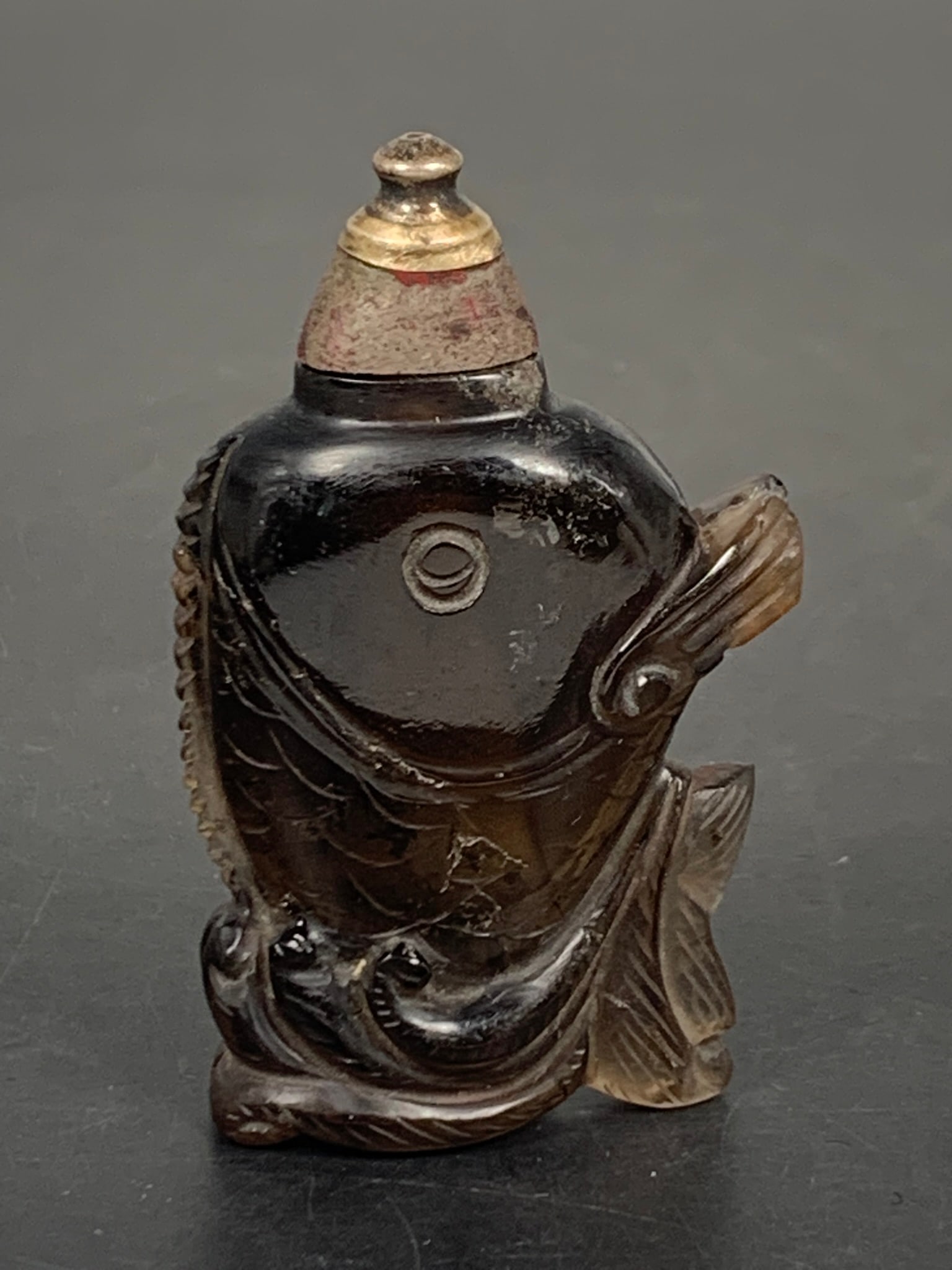 A Chinese Carved Glass Snuff Bottle: Carved in the shape of a fish, 3 in. high, 1.3/4 in. wide.