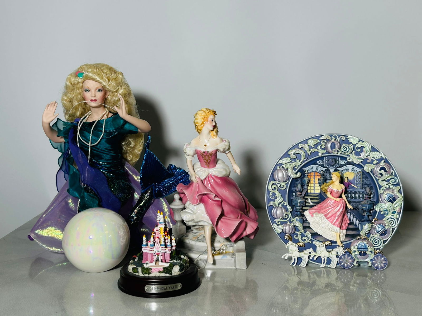 A Group of Four Vintage Decorative Objects: Comprising a limited edition hand-crafted 'Cinderella, The Magical Hour' dish, Franklin Mint Heirloom Recommendation; a Franklin Mint Cinderella red dress porcelain figure, GERDA NEUBACHER signature;