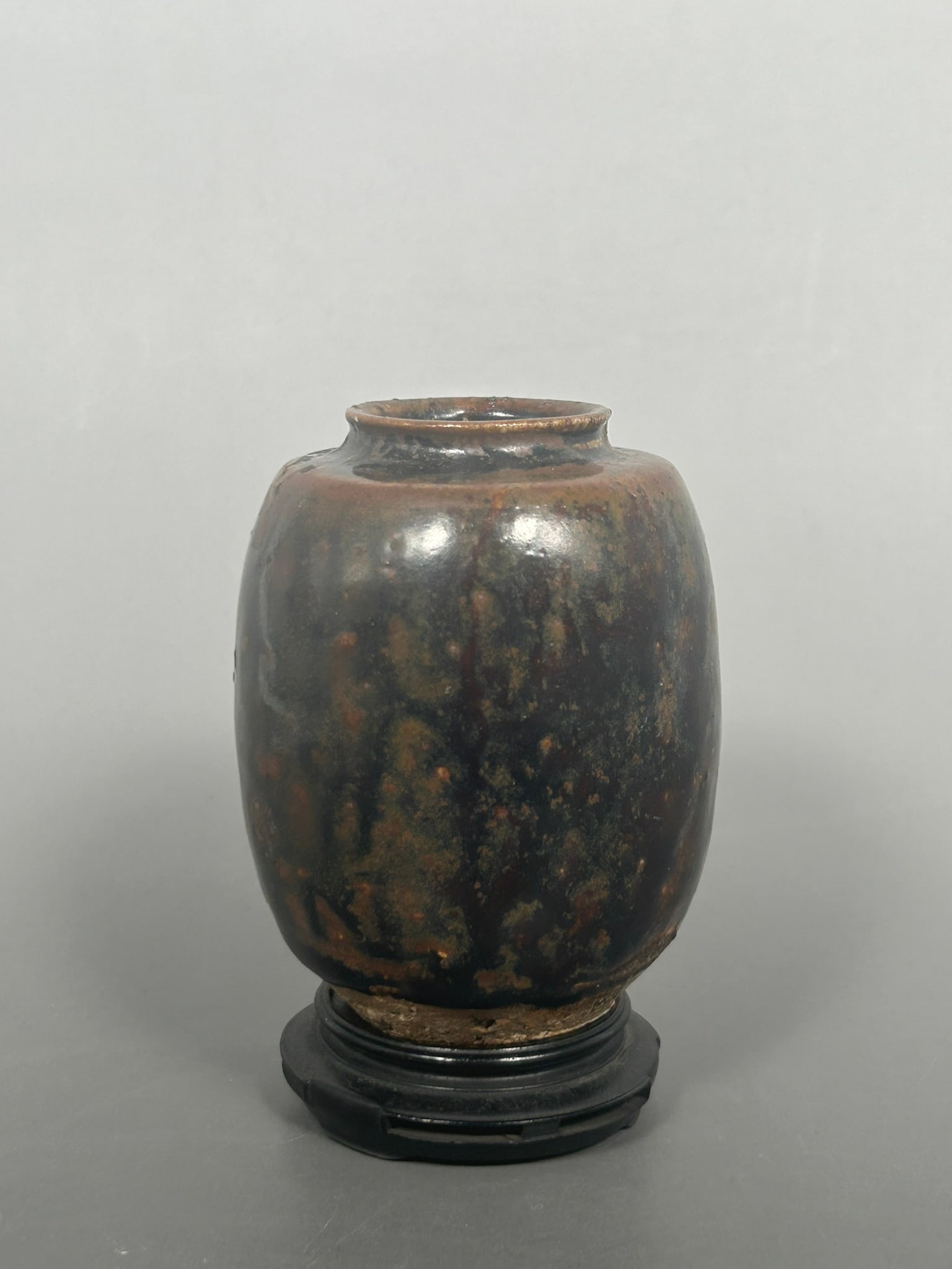 A Chinese Jizhou Blackish-Brown Glazed Jarlet: With a stand. The jarlet measures 3.3/8 in high, 2.1/2 in. wide.