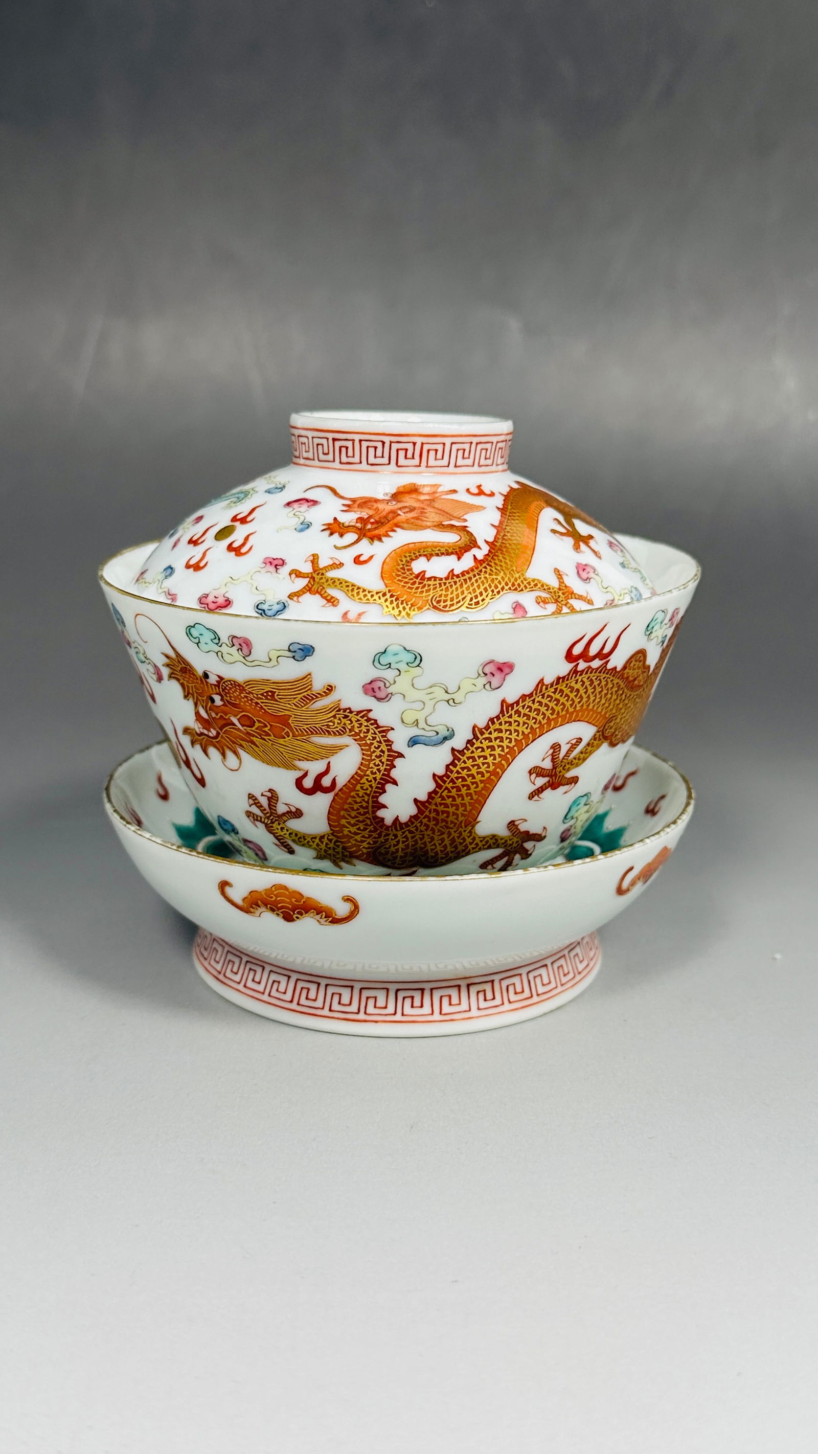 A Chinese Famille Rose Gilt-Decorated 'Dragons' Tea Cup, Cover, and Stand, Guangxu Period, Qing: 4.1/4 in. high, 4.1/4 in. wide overall.