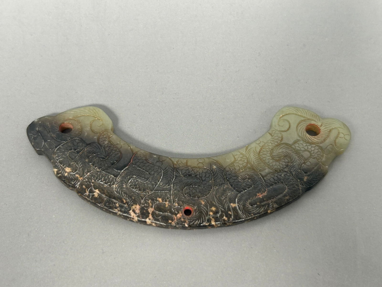 A Chinese Carved Celadon and Russet Jade 'Dragon' Pendant, Huang (1 of 8)