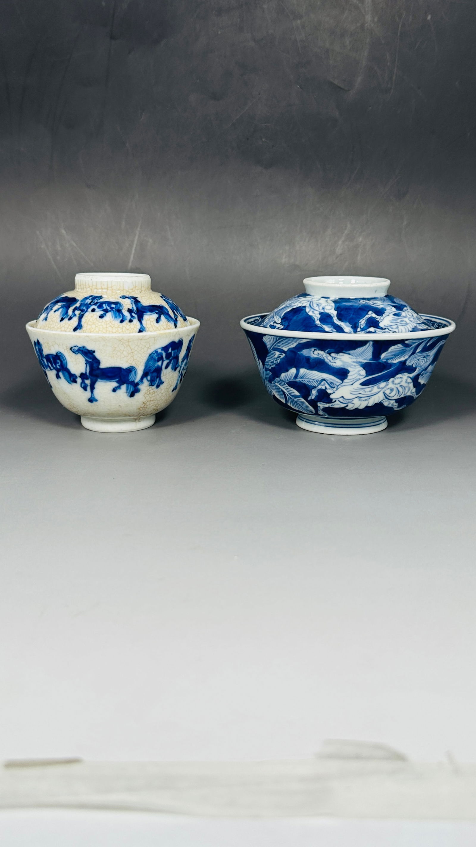 Two Chinese Porcelain Tea Cups and Covers: Comprising a blue and white cup and cover, 3.1/4 in. high, 5 in. diam.; and a underglaze-blue decorated crackle-glazed cup and cover, 'Ruoshen Zhen Cang' mark to the base. 3.1/2 in. high, 4 in. diam.