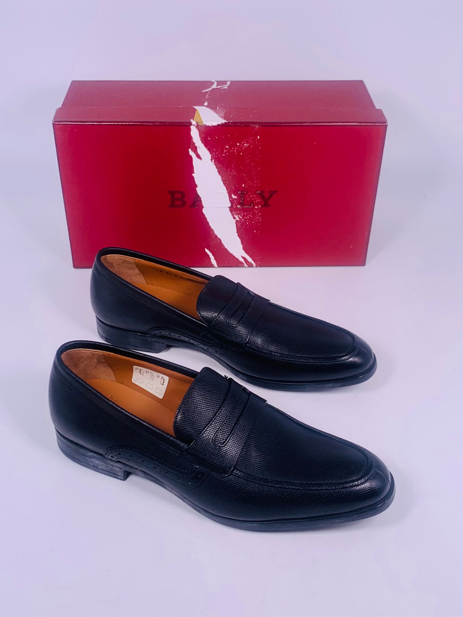 A Pair of Bally Men's Black Loafers Size 9, Swiss Made: With original box and cloth carrying bag.