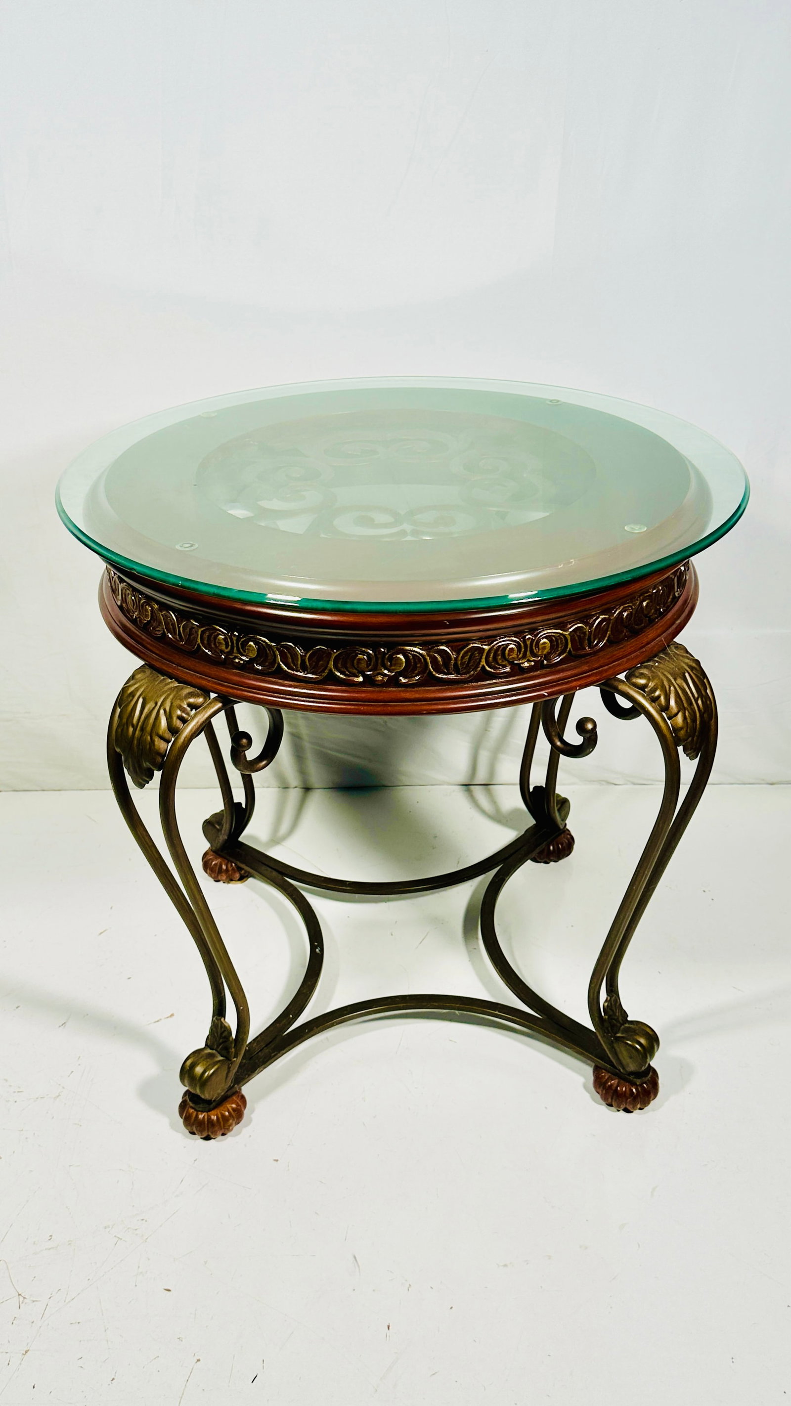 A Chinese Carved Wood Round Table: With a glass top, 29.1/2 in. high, 33 in. wide including glass top.