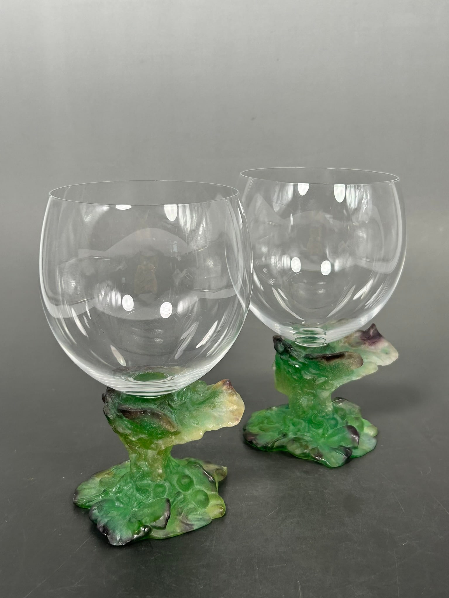 A Pair of Daum Bacchus Coupelle Pate de Verre Glass and Crystal Bowl Goblets: Daum France' marks to the undersides. 6.1/8 in. high, 3.3/4 in. wide each.