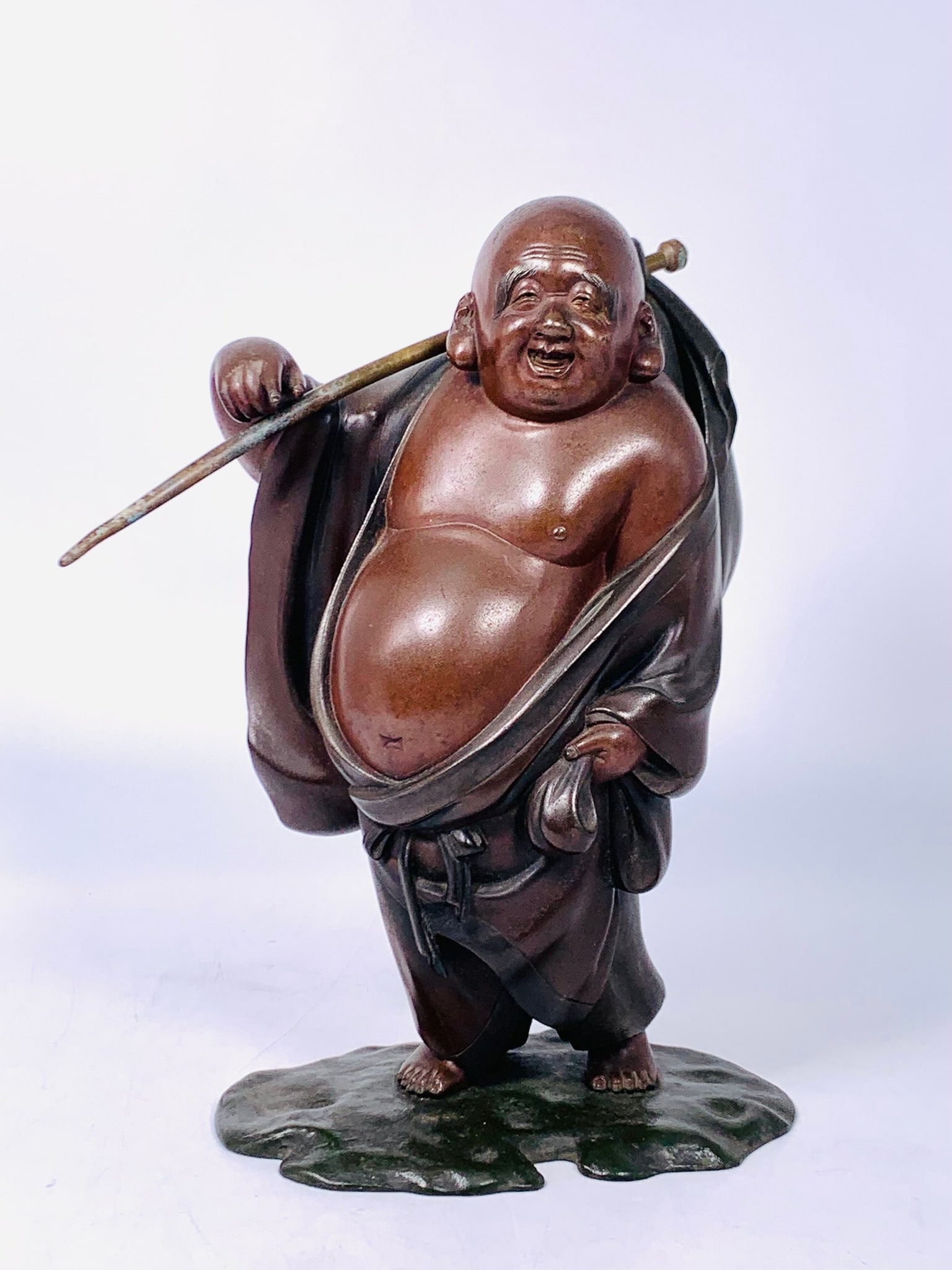 A Japanese Bronze Figure of Budai, Joshin Mark: 12.5/8 in. high, 10.1/4 in. wide.
