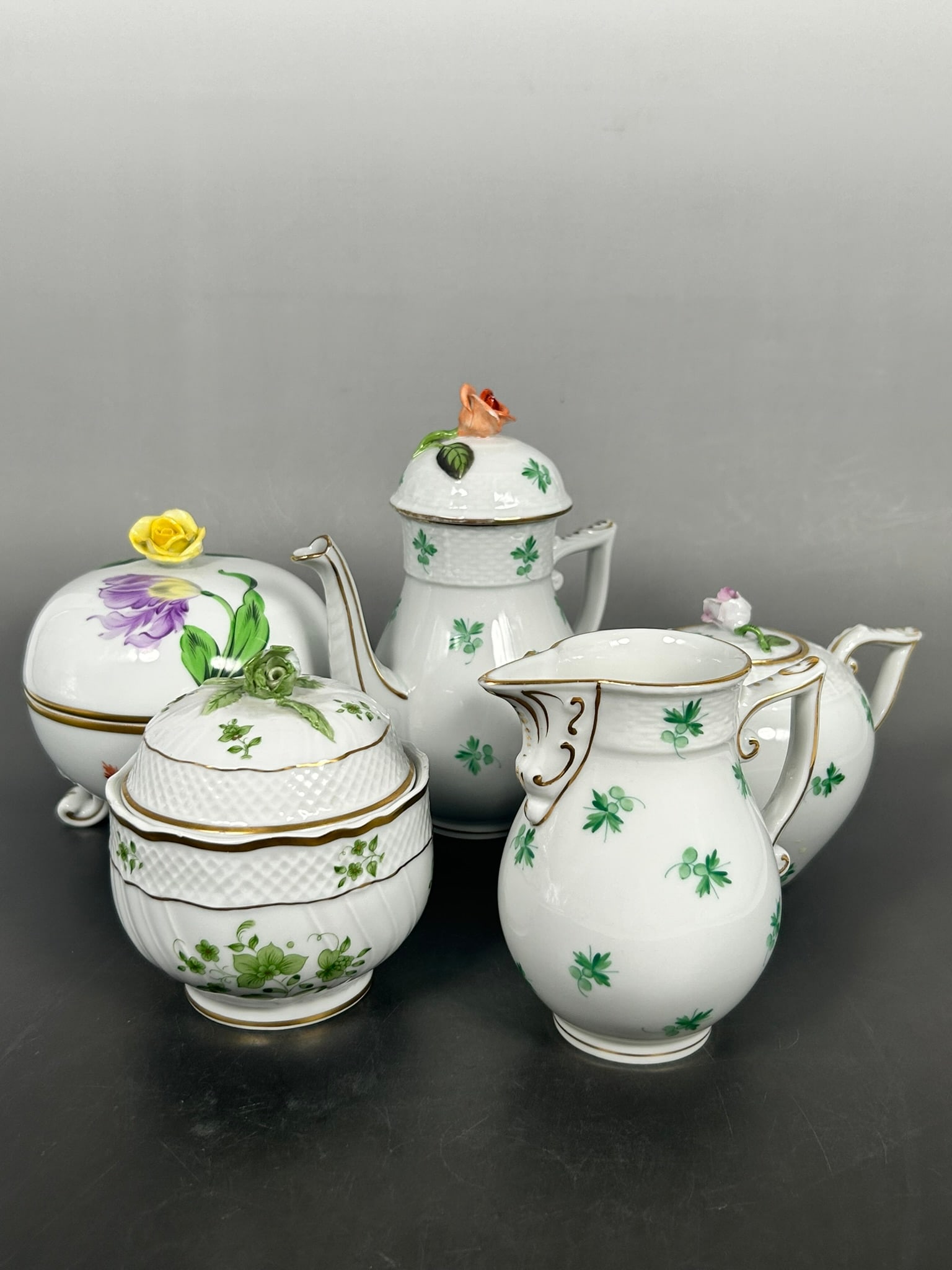 A Group of Five Herend Gilt-Decorated Tea/Coffee Set (Part): Comprising a coffee pot, 6.1/2 in. high, 5.1/2 in. wide; a teapot, 4 in. high, 6.1/2 in. wide; a milk jug, 4.1/4 in. high, 4 in. wide; a sugar bowl and cover, 4.1/8 in. high, 3.1/2 in. wide; and a pot