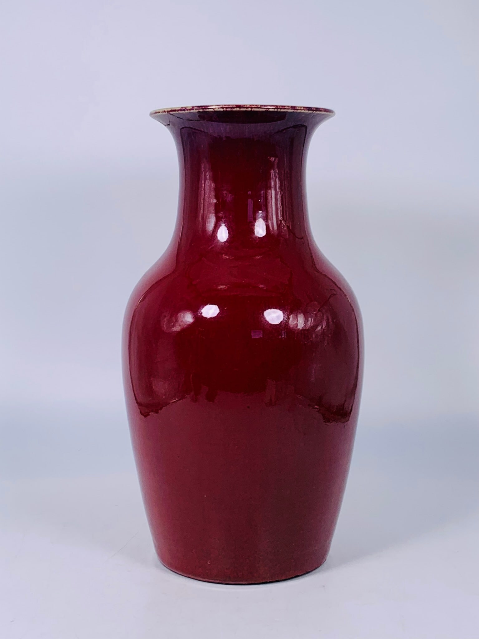 A Chinese Red-Glazed Vase, Qing Dynasty: 14.1/2 in. high, 7.1/2 in. wide.