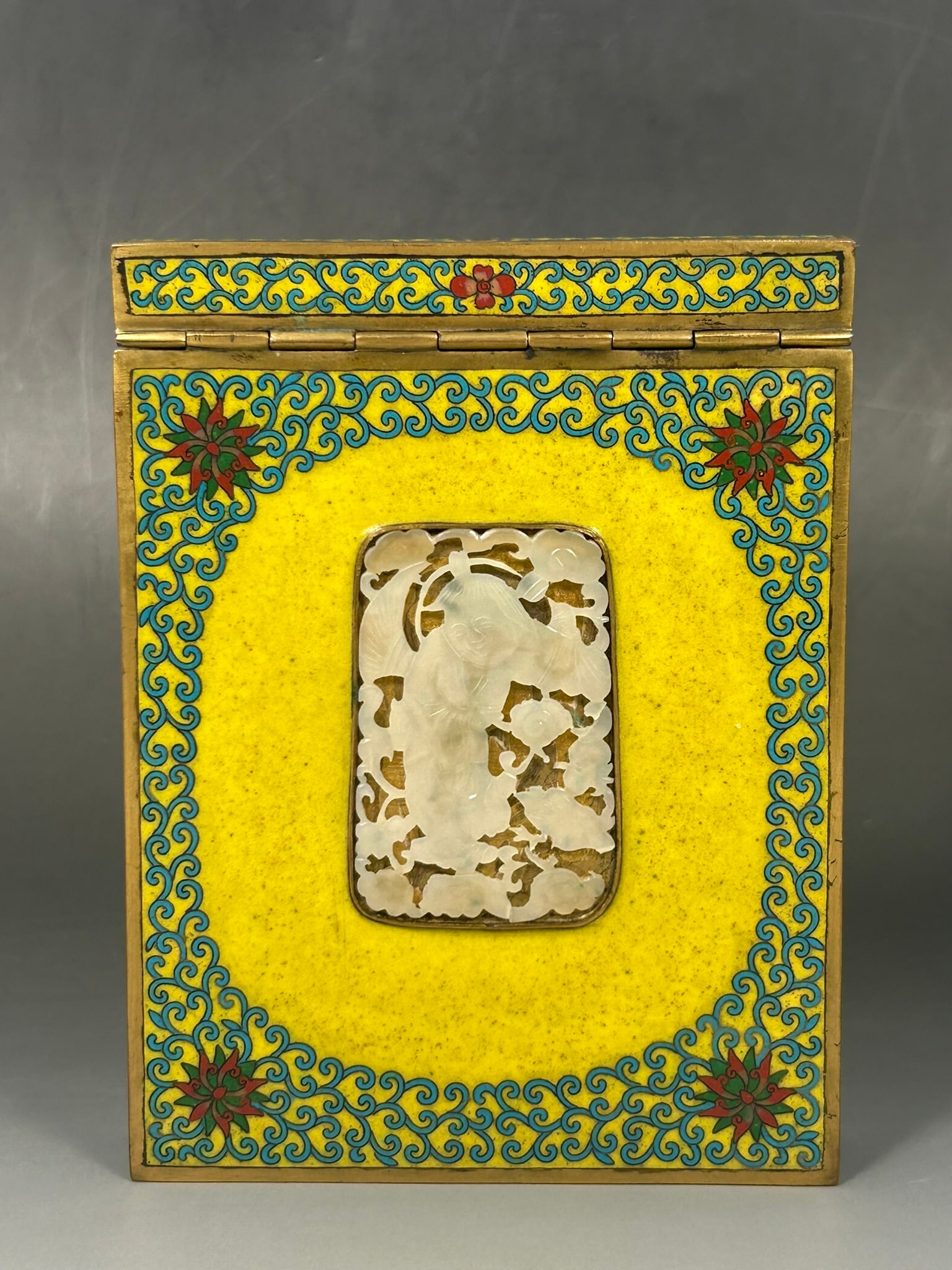 A Chinese Export Jade Plaque-Inset Cloisonne Enamel Paper Holder: The 'Liu Hai and Toad' jade plaque measures 2.3/8 in. high, 1.5/8 in. wide; the paper holder measures 6 in. long, 4.1/2 in. wide.