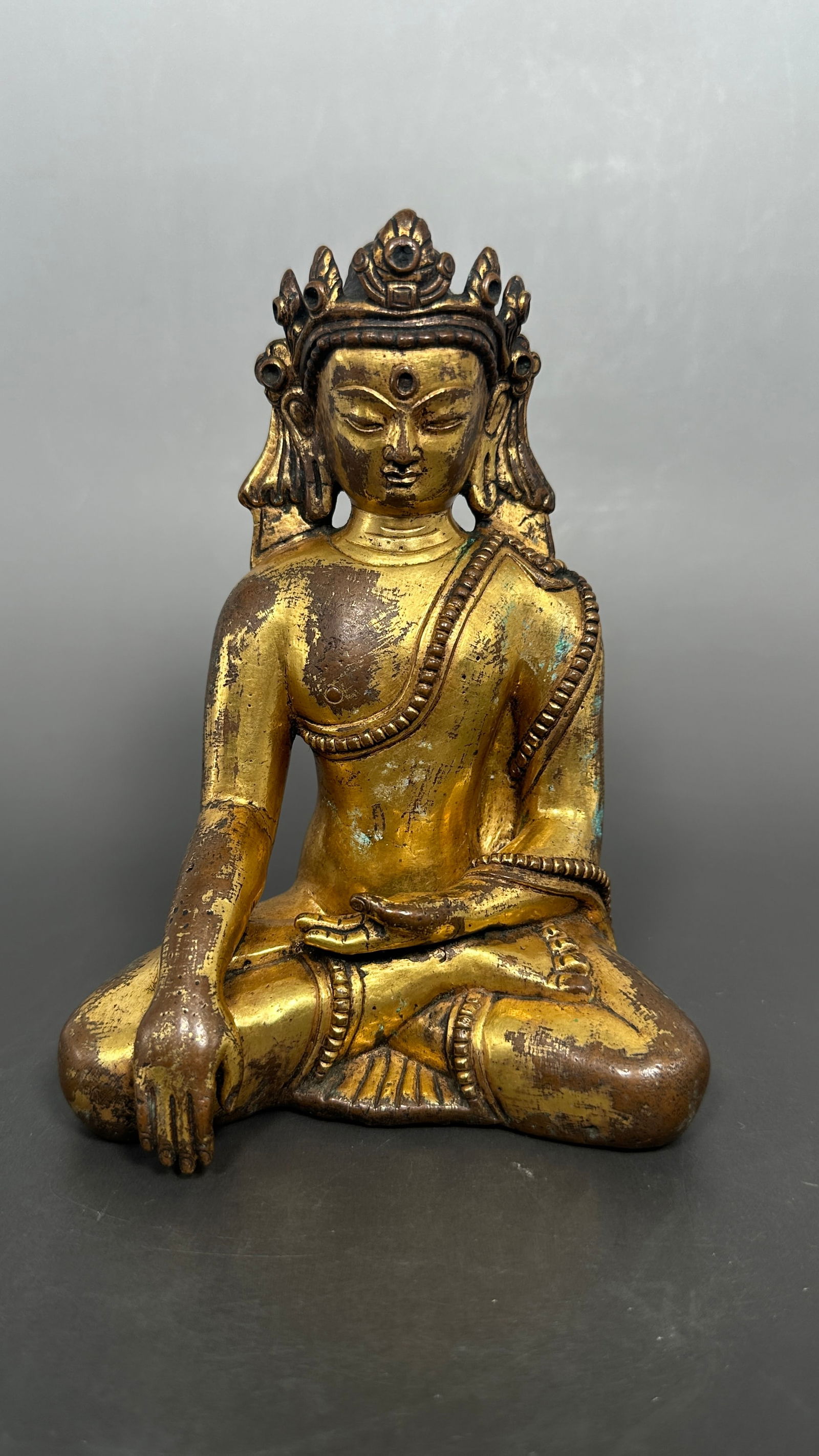 A Tibetan Gilt-Bronze Figure of Crowned Buddha (1 of 7)