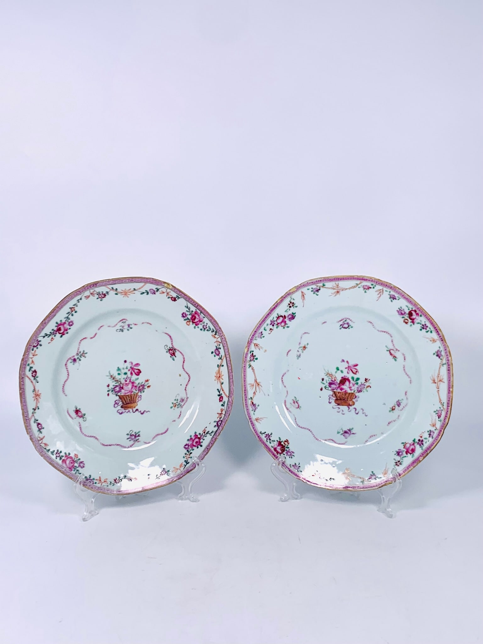 A Pair of Chinese Export Famille Rose 'Flower Basket' Dishes: 9 in. diam. each.