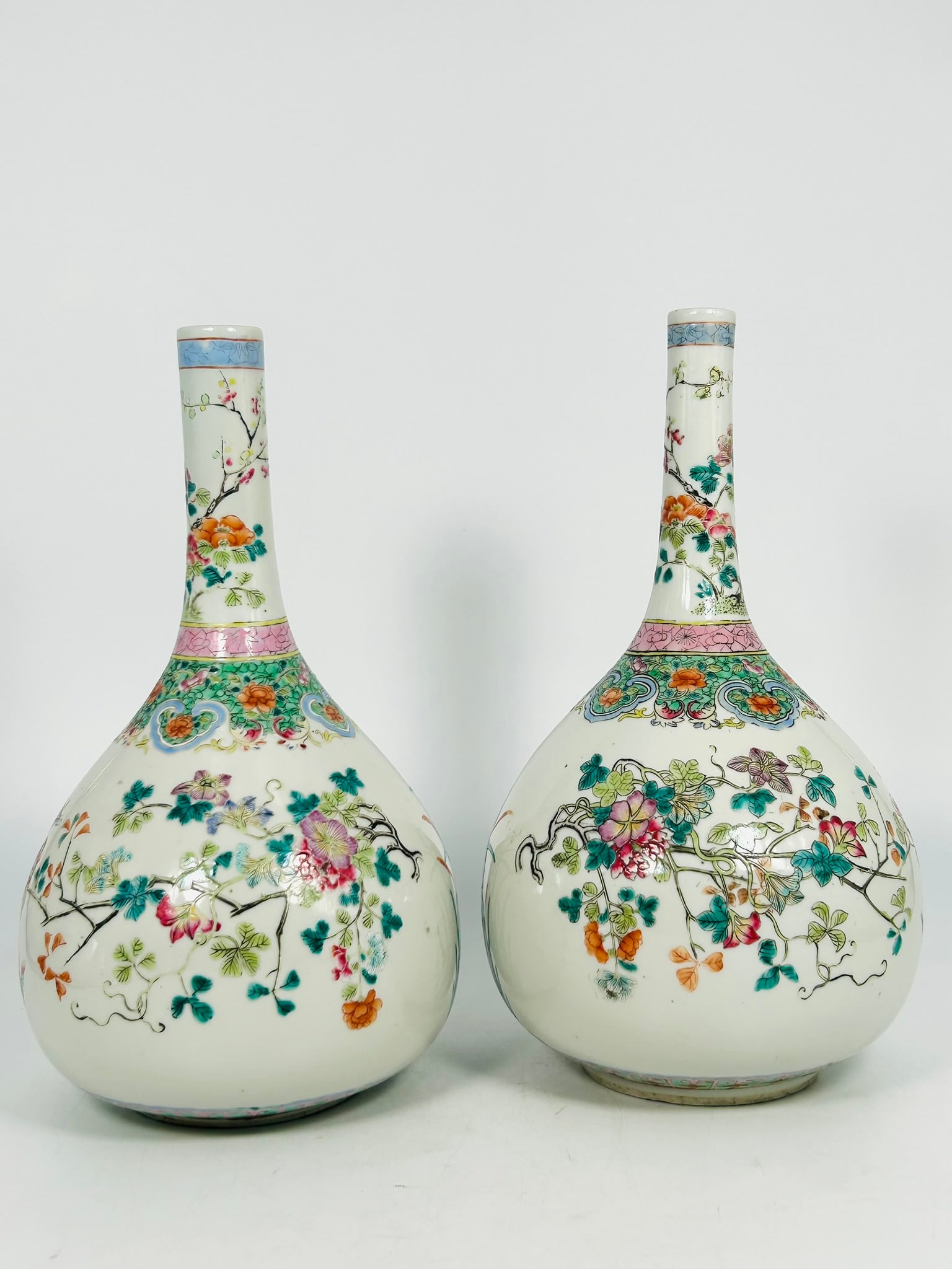 A Pair of Chinese Famille Rose 'Butterflies and Flowers' Bottle Vases, Late Qing Dynasty: 12 in. high, 7 in. wide. each.