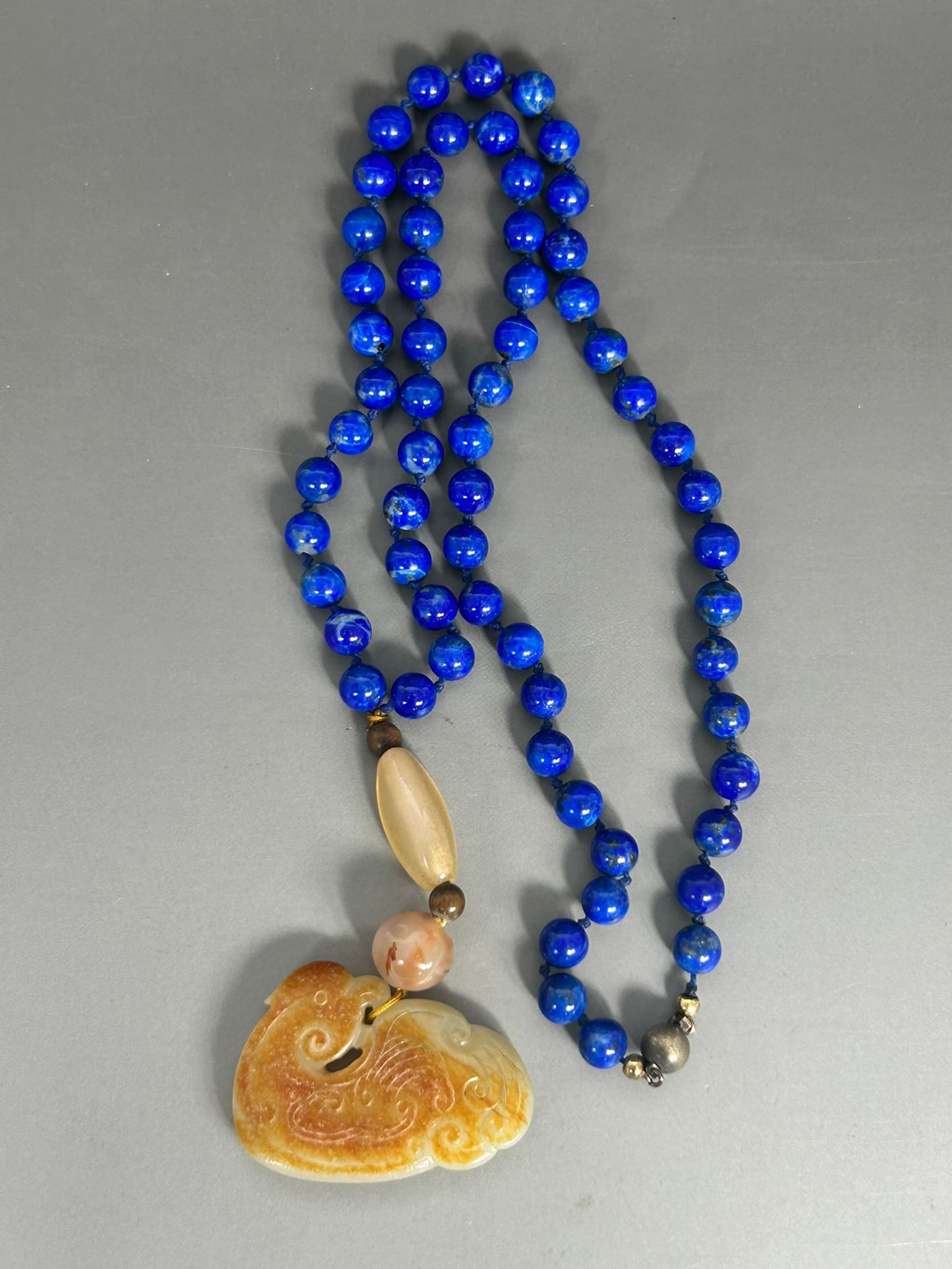 A Chinese Carved White and Russet Jade 'Bird' Pendant, 19th Century (1 of 7)