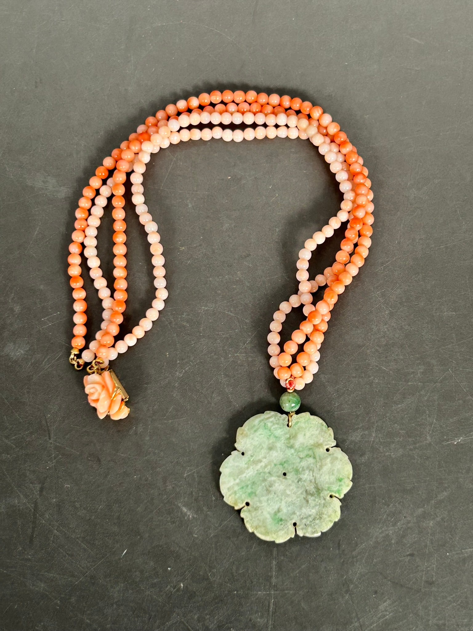 A Chinese String of Coral Beads, Necklace: With a jade pendant, 1.3/8 in. wide; the necklace measures 11 in. long overall.