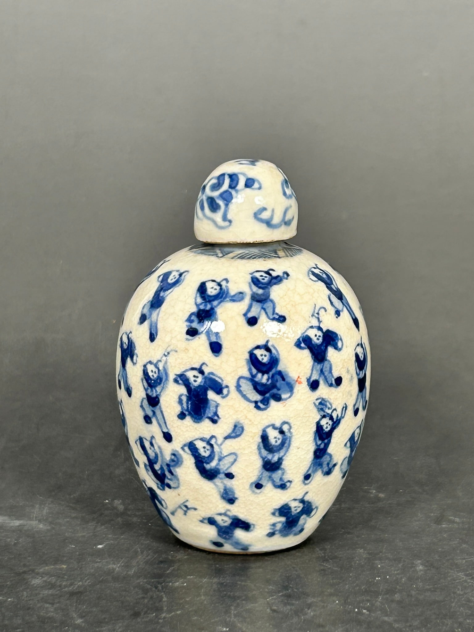 A Chinese Miniature Blue and White 'One Hundred-Boys' Jar and Cover: 3.1/8 in. high, 2 in. wide.