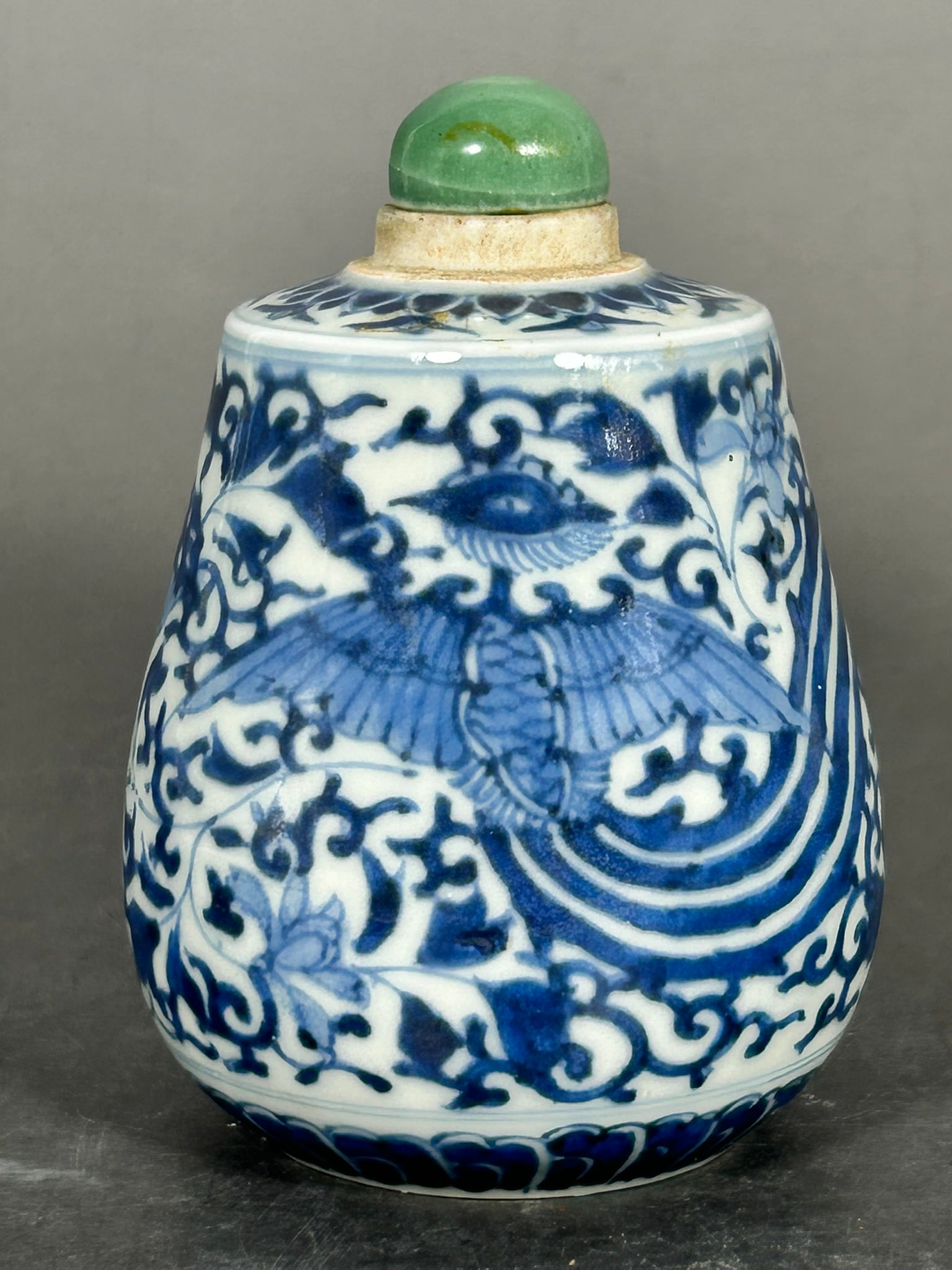 A Chinese Blue and White 'Phoenix' Snuff Bottle: 4.1/4 in. high, 3 in. wide.