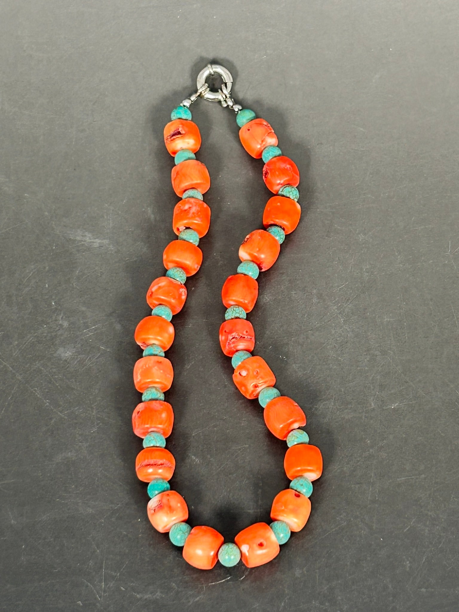 A String of Coral and Turquoise Beads, Necklace: Comprising twenty-two coral beads and twenty-three turquoise beads. The coral beads measures around 5/8 in. wide each, and the turquoise beads measures around 1/4 in. diam. each. 18 in. long for the n
