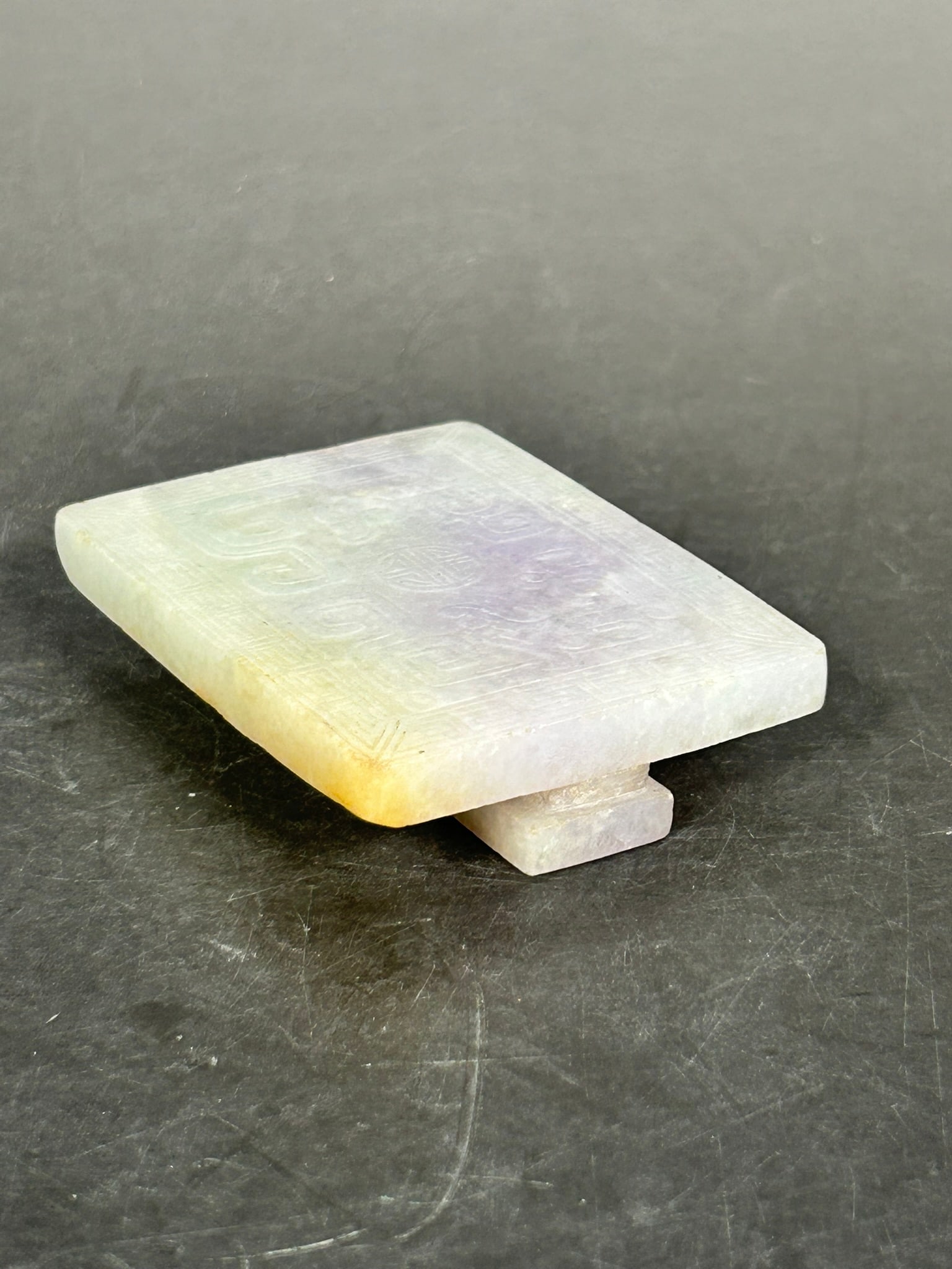 A Chinese Carved Jadeite Belt Buckle: 3.1/8 in. long, 2.1/4 in. wide.