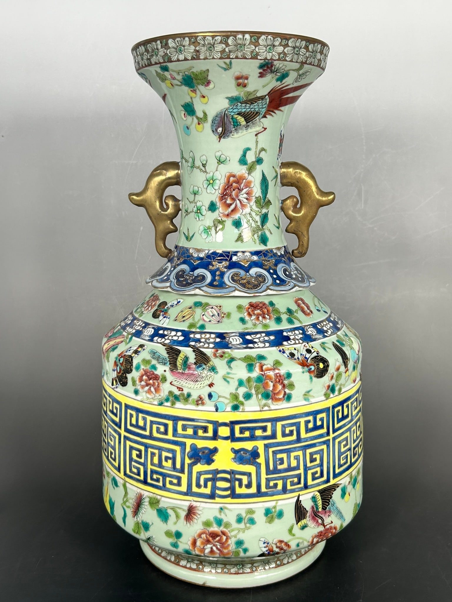 A Chinese Famille Rose Celadon-Glazed 'Birds, Butterflies, and Flowers' Vase, Qing Dynasty: 15.1/2 in. high, 8 in. wide.