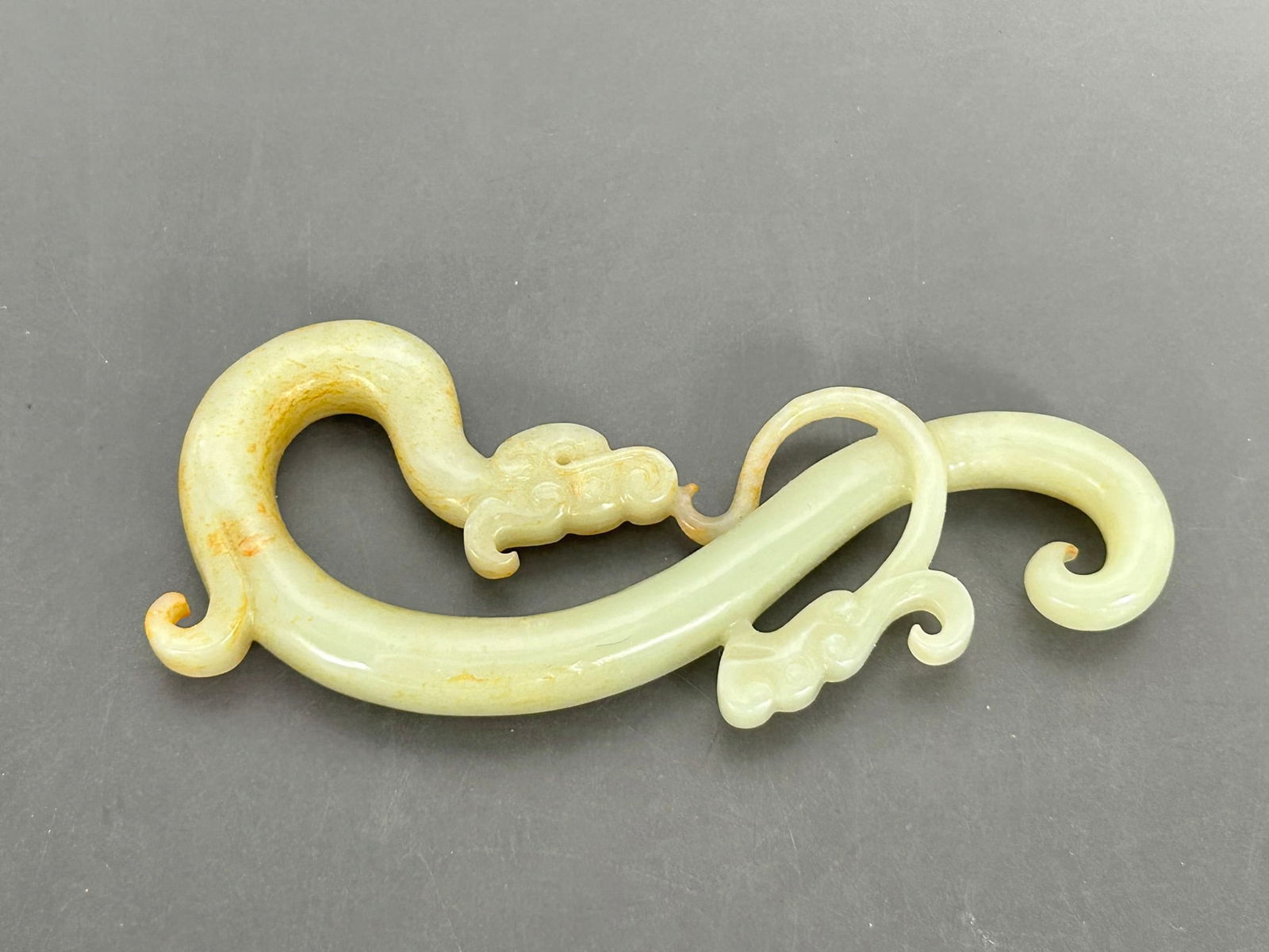 A Chinese White and Russet Jade Carving of 'Dragon' Pendant (1 of 7)