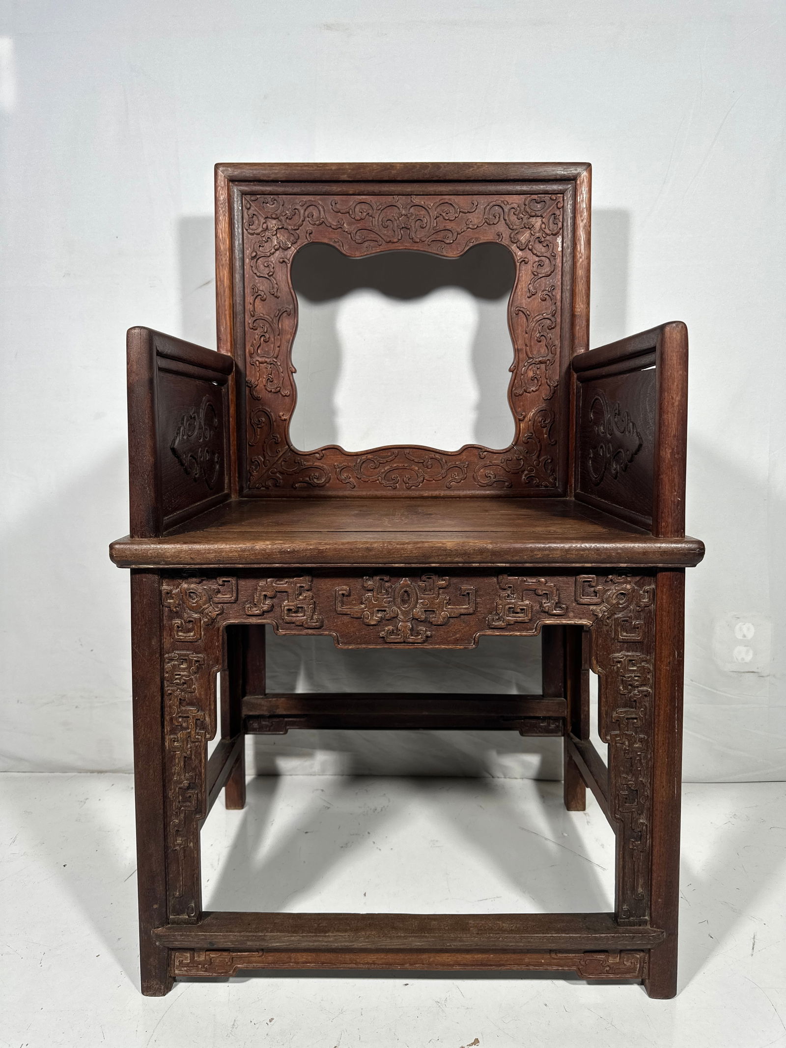A Chinese Tielimu Lowback Armchair: 38.1/2 in. high, 23.1/2 in. wide, 17.1/2 in. deep.