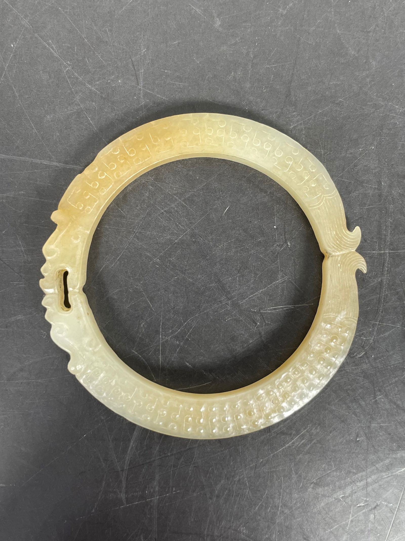 A Chinese Carved White and Russet 'Dragon' Bracelet, Ming Dynasty (1 of 9)