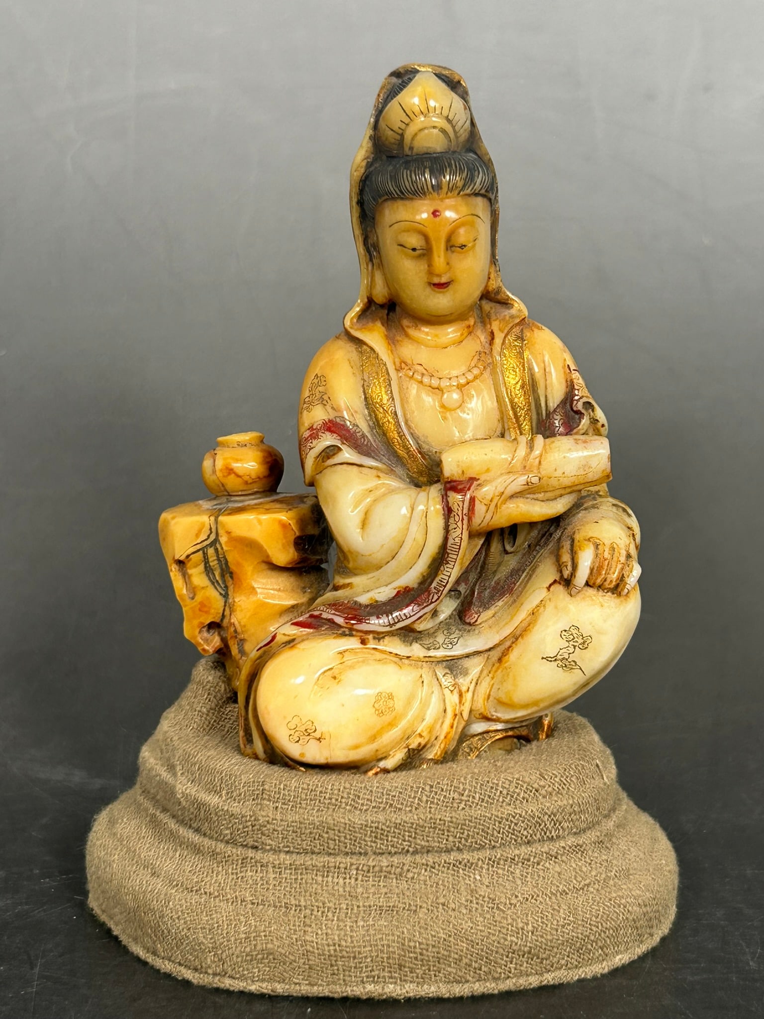 A Chinese Carved Shoushan Soapstone Figure of Guanyin: With a cloth base. The figure measures 4.1/4 in. high, 3 in. wide.