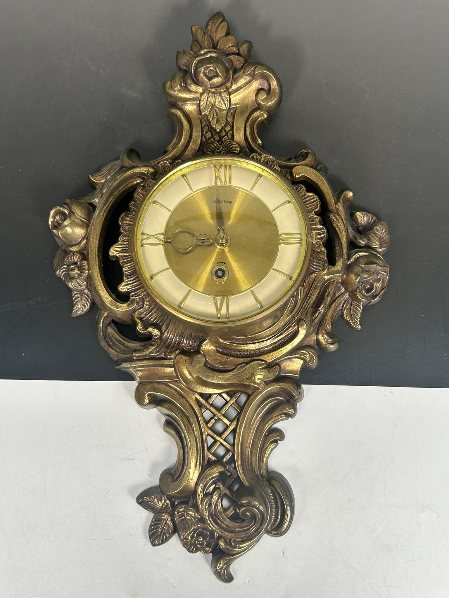 A Vintage Solid Brass Baroque 8 Day Jeweled Wall Clock: 17.1/2 in. high, 10.3/4 in. wide.