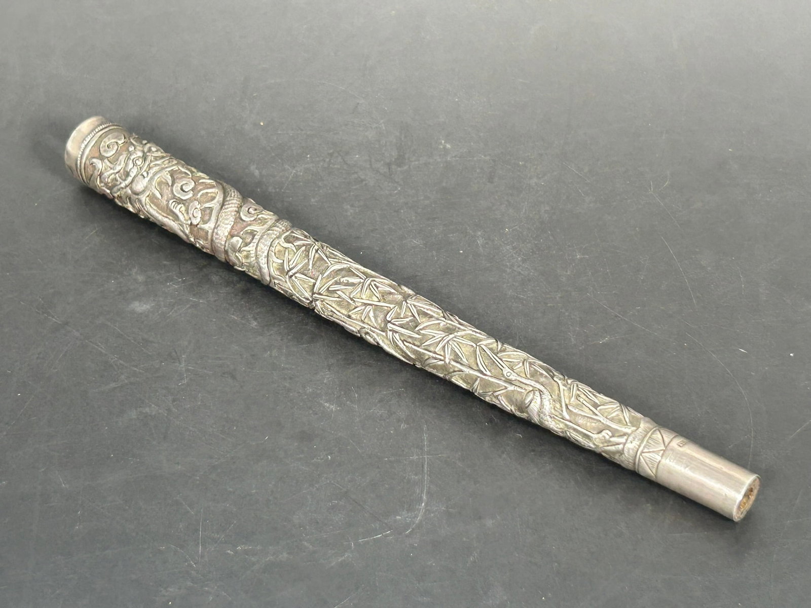 A Japanese Carved Silver 'Dragon, Crane, and Bamboo' Walking Stick Handle: 8.7/8 in. long, 3/4 in. wide.