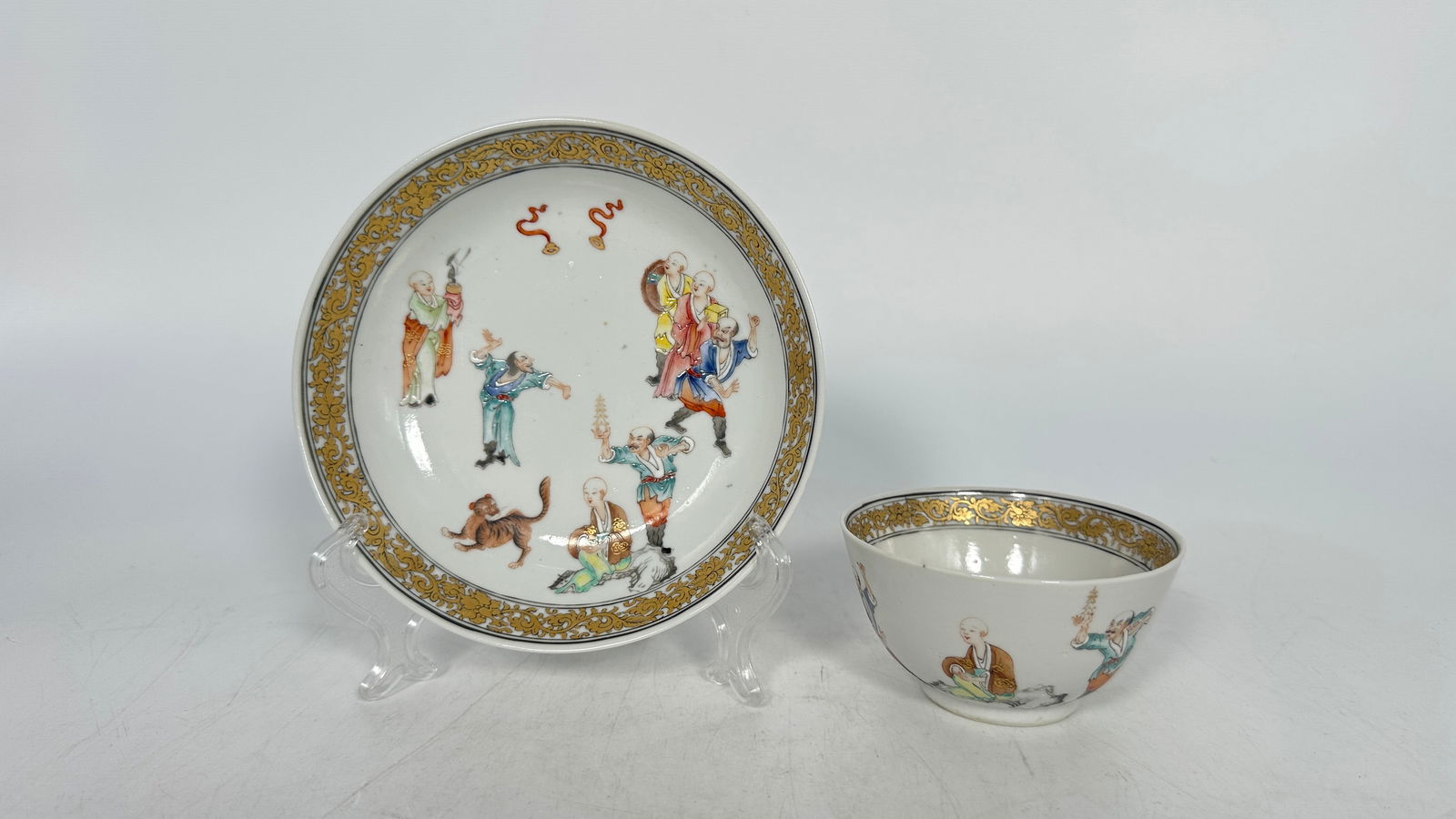 An 18th Century Chinese Famille-Rose “Luohan” Cup and Saucer: Decorated with Luohan figures in a landscape setting.Saucer Diameter: 5 1/2 in.Cup Diameter: 3 1/2 in.Cup Height: 1 3/4 in.Condition: good, no damage or restoration.