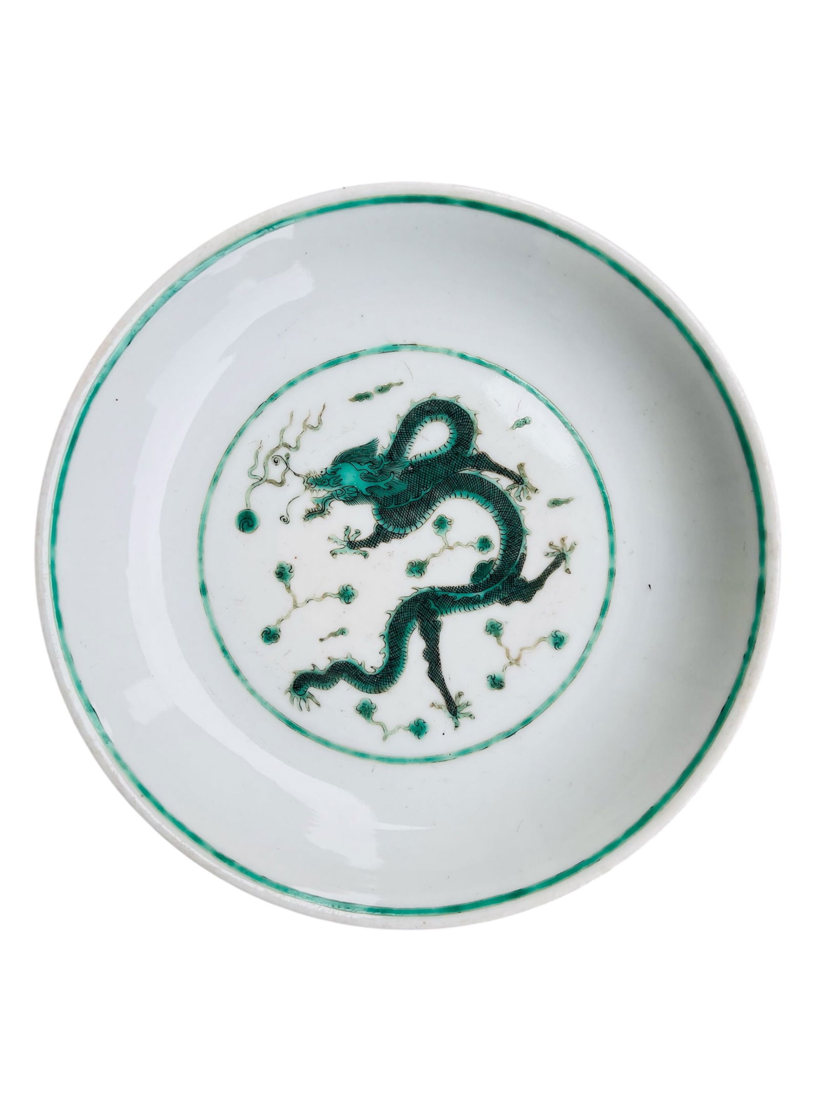 A Chinese Green Dragon Plate, Qianlong Mark, Qing Dynasty: Chinese Qing Dynasty green-glazed plate decorated with a dragon motif, bearing a rare black-enamel Da Qing Qianlong Nian Zhi mark.Diameter: 8 inches.Condition: good.
