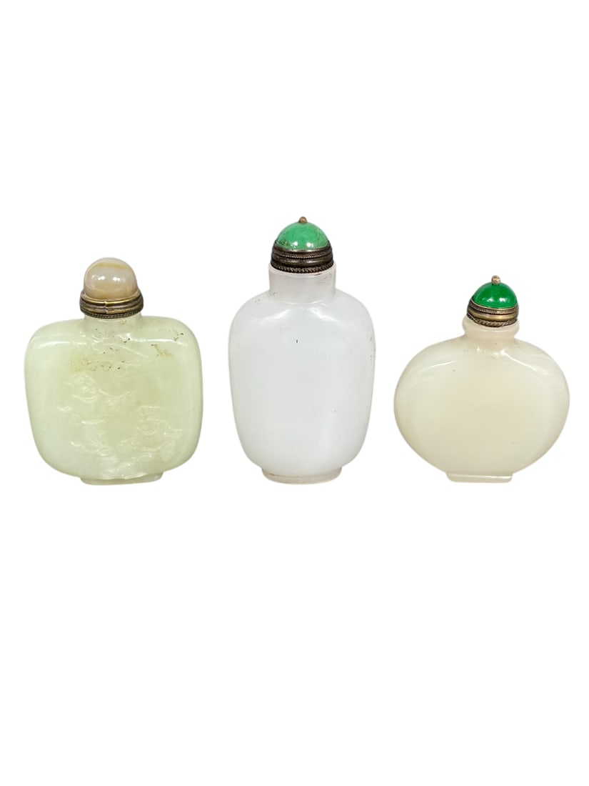 A Group of Three Chinese Jade Snuff Bottles: The tallest measures 2.7/8 in. high, 1.5/8 in. wide.