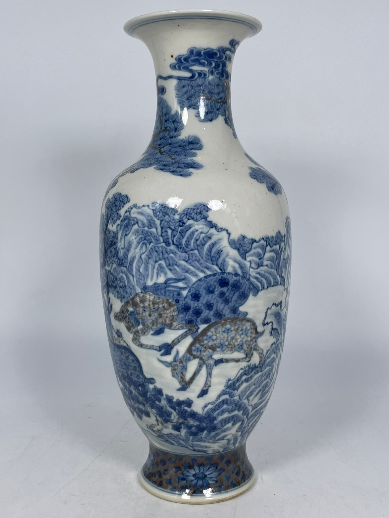 A Chinese Underglaze Blue and Copper-Red-Decorated 'Deer and Pine Tree' Vase: 13.1/2 in. high, 5.1/4 in. wide.