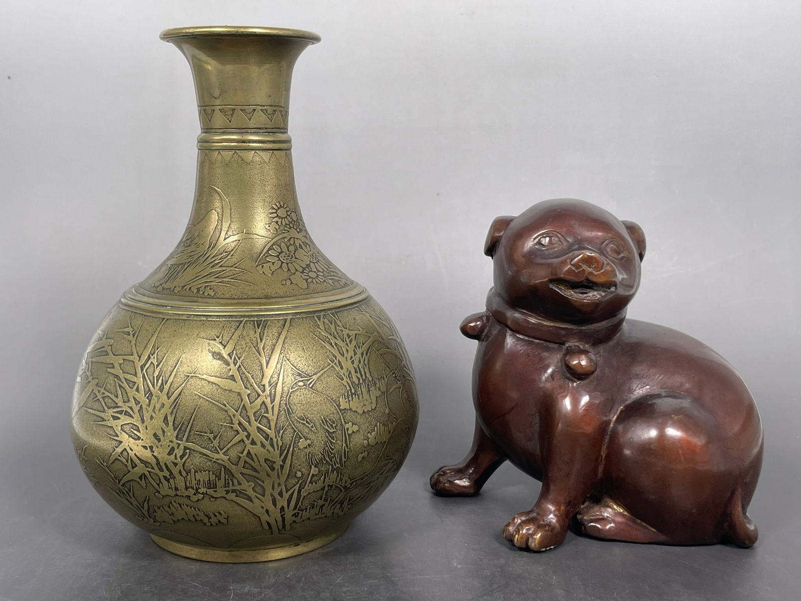 Two Japanese Metal Objects: Comprising a petite Taishou style bronze figure of a dog, 5.7/8 in. high, 6 in. wide; and a brass vase, 8.5/8 in. high, 5.3/4 in. wide. Property of a Private Maryland Collector.