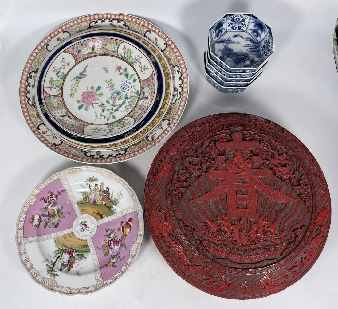 A Group of Eleven Porcelain Ware and a Red Box and Cover: Comprising a large red box and cover, 5 in. high, 13.1/2 in. diam.; a set of five blue and white octagonal 'riverscape' bowls, 2.1/4 in. high, 5.1/4 in. wide each; a famille rose 'figural' charger,