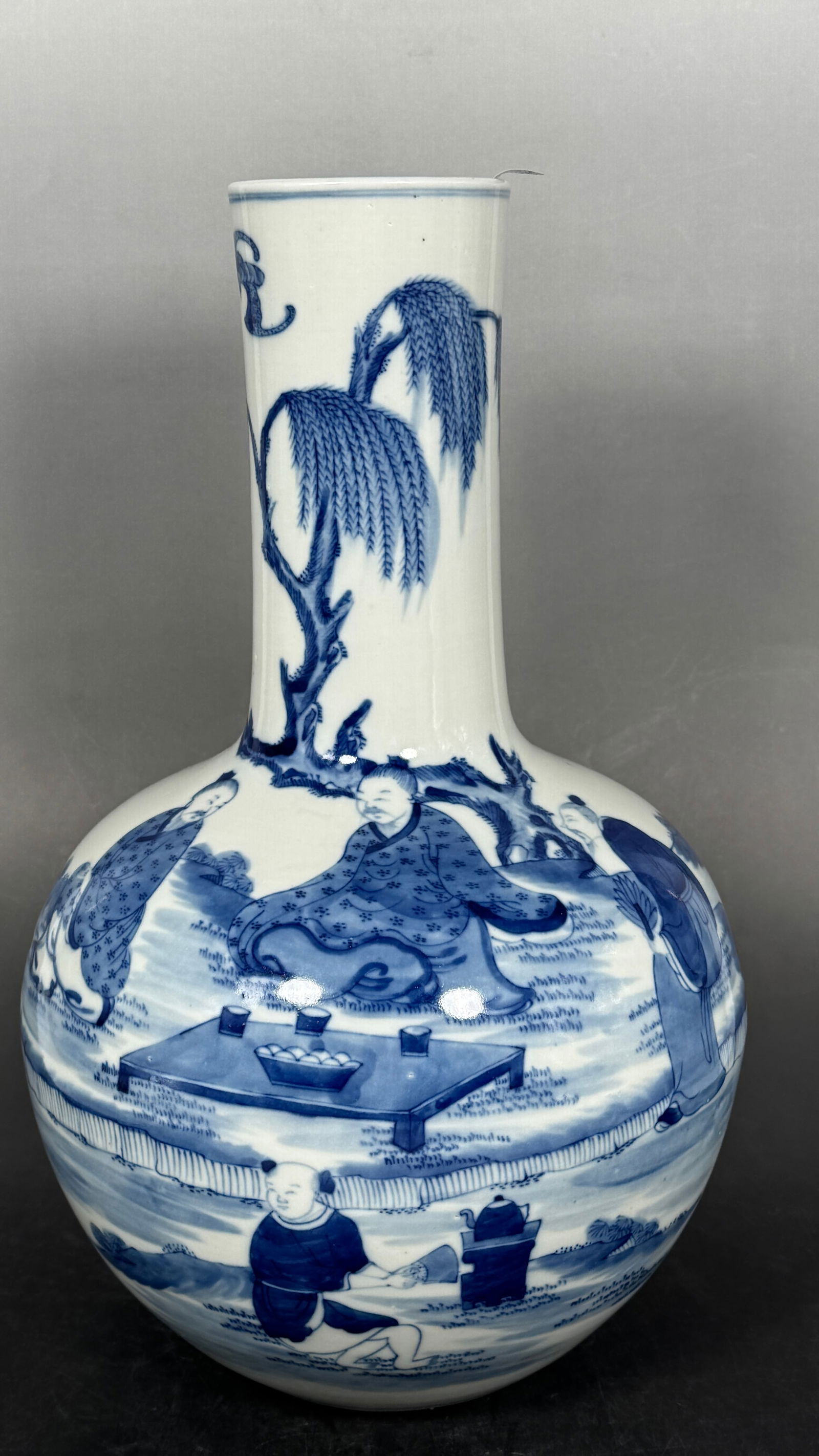 A Chinese Blue and White 'Scholars and Attendant' Vase: 13.1/2 in. high, 8.1/4 in. wide.