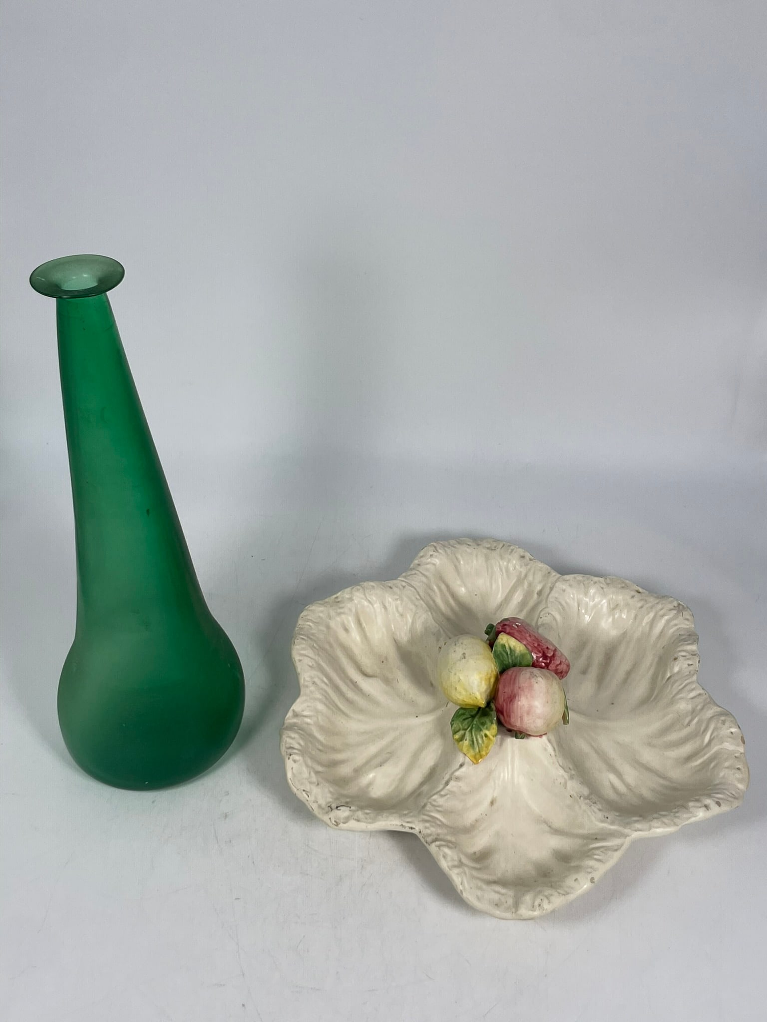 Two Decorative Art Objects: Comprising an Italian cabbage leafy vegetable serving dish, 2.3/4 in. high, 14.1/2 in. wide; and a green glass tall vase, 15 in. high, 5.1/4 in. wide.