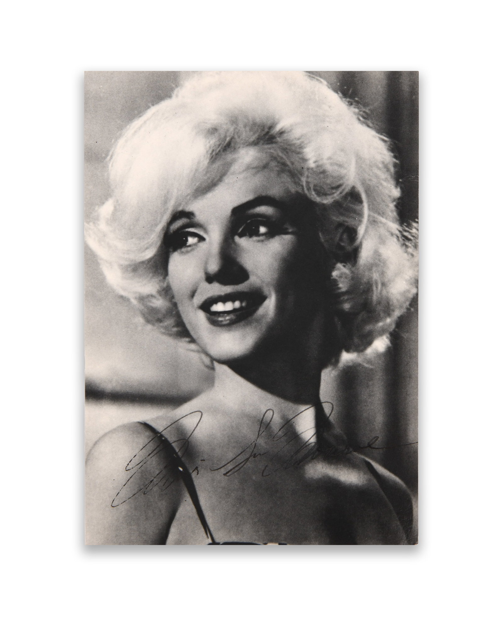 Marilyn Monroe (1926-1962), Signed Portrait Postcard Photograph: Provenance and Authenticity:This item includes a certificate of authenticity.The present item is a black-and-white photographic postcard depicting Marilyn Monroe in a classic studio portrait pose that