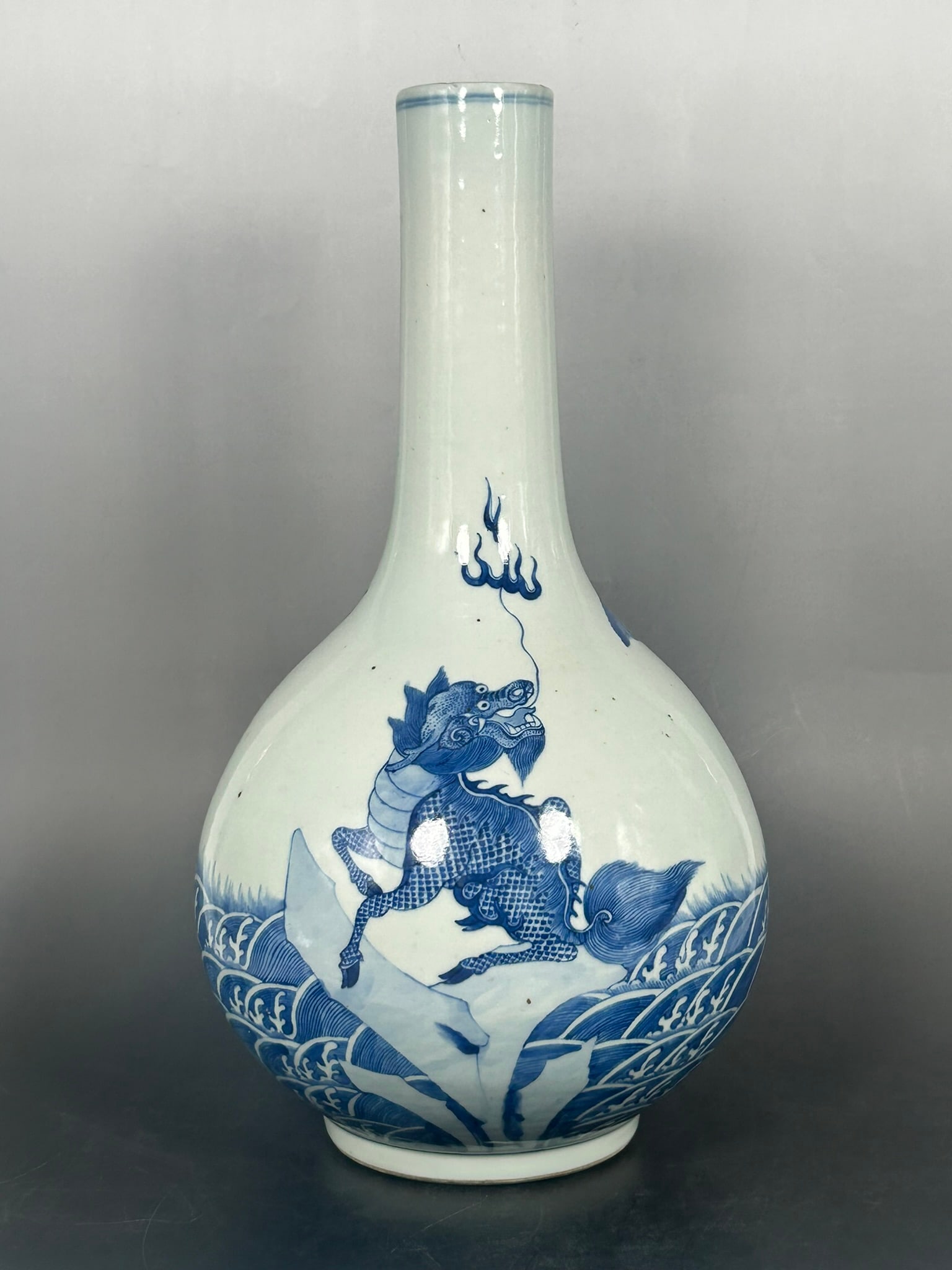 A Chinese Blue and White Porcelain Bottle Vase - Qing Dynasty: Decorated with a mythical animal. 16.1/4 in. high, 8.3/4 in. wide. Provenance: The Eric Cohler Collection.