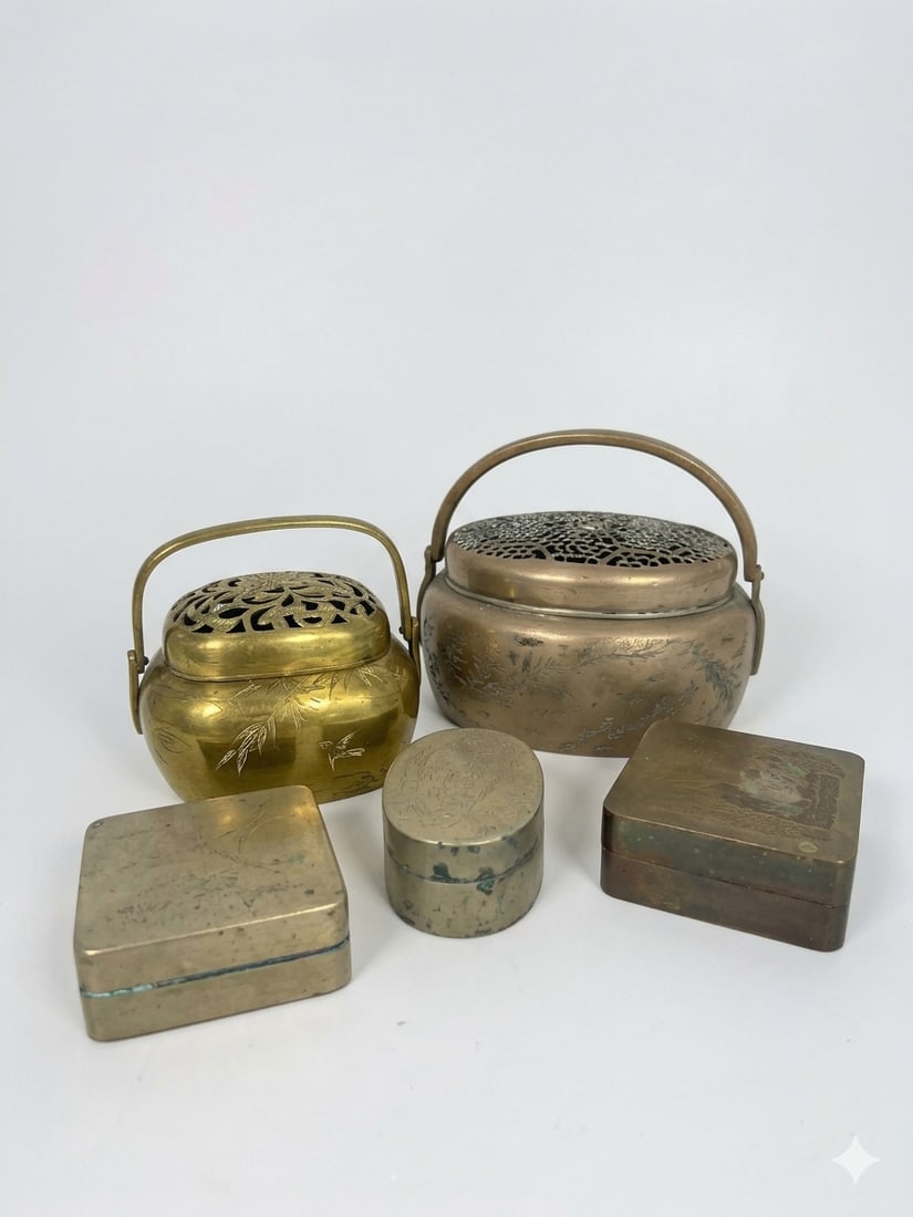 A Group of Five Chinese Brass Hand Warmers and Ink Boxes: The larger hand warmer measures 4.1/2 in. high, 5.1/4 in. wide with handle erected; the smaller one measures 3.3/4 in. high, 4 in. wide; the larger rectangular ink box with a signature Chen Yinsheng o