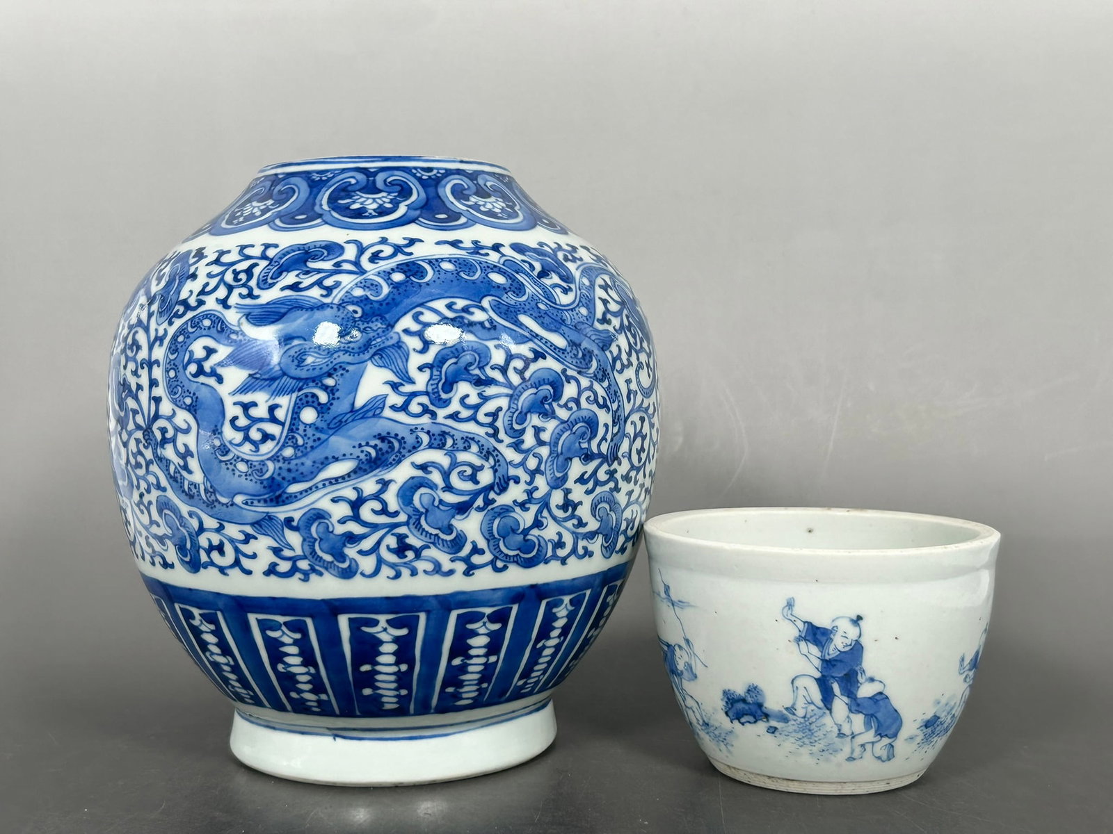 Two Chinese Blue and White Porcelain Ware, Qing Dynasty: Comprising a 'dragon' jar, 7.1/2 in. high, 6.3/4 in. wide; and a small 'boys' bowl, 3 in. high, 4.3/8 in. wide.