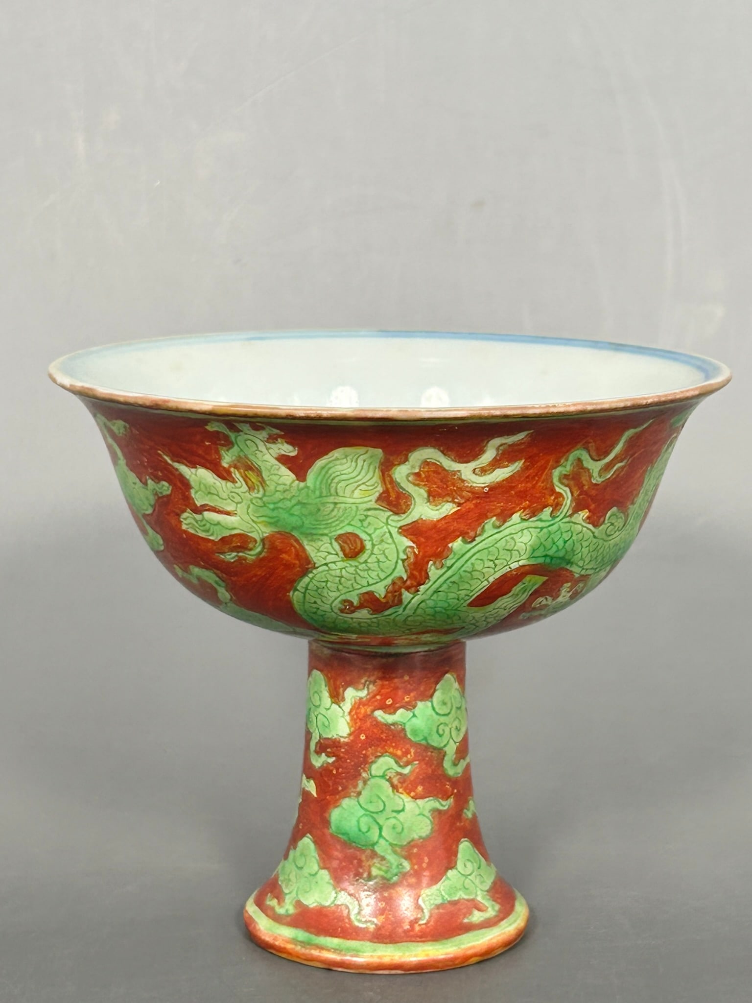 A Chinese Green-Decorated Red-Ground 'Dragon' Stem Cup, Ming Dynasty: A Xuande mark to the inner bottom of the cup. 3.1/2 in. high, 4 in. wide.