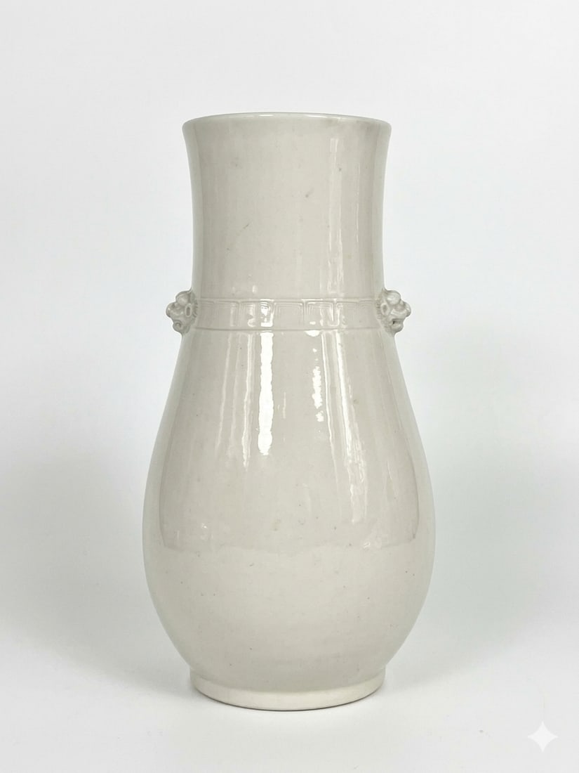 A Chinese White-Glazed 'Lion Double Handle' Vase: 9.1/2 in. high, 5 in. wide.