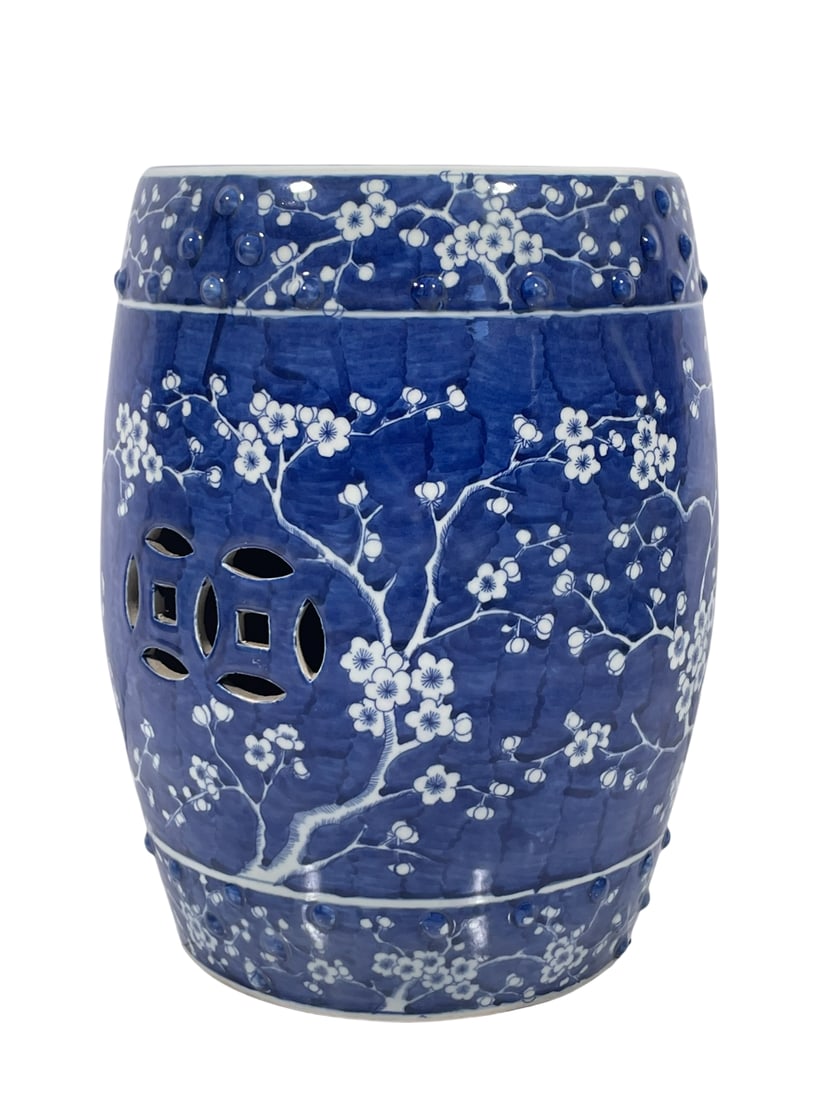 A Chinese Blue and White 'Blossoming Plum Branches' Porcelain Garden Stool: 17 in. high, 12.1/2 in. wide.